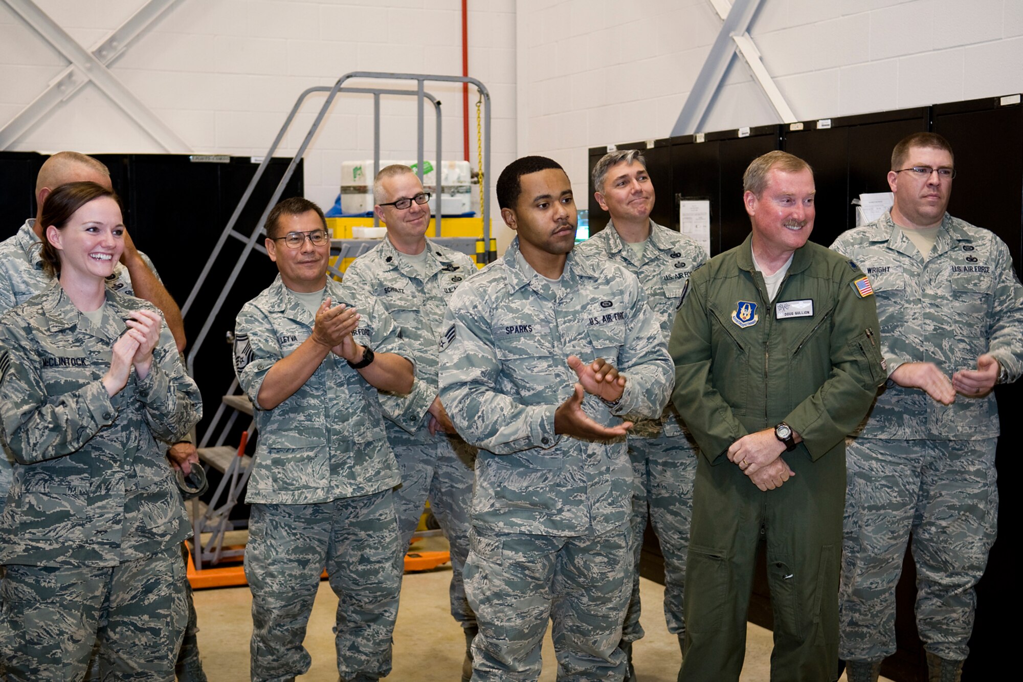 A crowd of 434th Air Refueling Wing Airmen applauds as a ribbon is cut on a new boom operator weapons system trainer at Grissom Air Reserve Base, Ind., Sept. 27, 2013. Grissom's BOWST, which cost approximately $3 million, will provide significant benefits by reducing the required number of flight hours in a KC-135 Stratotanker for boom operators to maintain training and currency. (U.S. Air Force photo/Tech. Sgt. Mark R. W. Orders-Woempner) 
