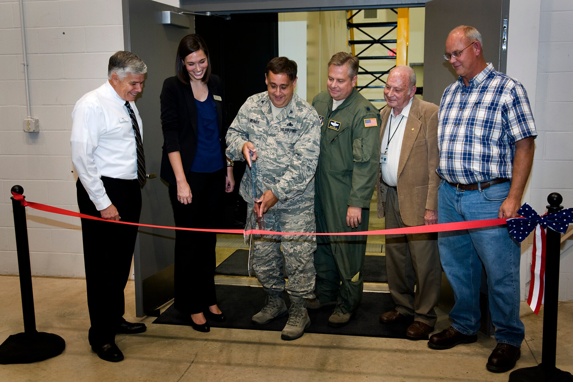 Grissom leadership joins with congressional representation and community leaders to cut a ribbon on opening a new boom operator weapons system trainer at Grissom Air Reserve Base, Ind., Sept. 27, 2013. From left to right are Gary Beebe, a contract site manager for the BOWST; Meredith Perks, regional director for Sen. Joe Donnelly; Col. Paul Weimer, 434th Maintenance Group commander; Lt. Col. Brian Hollis, 434th Operations Support Squadron chief of plans; John Gilpin, Grissom Community Council president; and Jeff Snider, 434th Civil Engineer Squadron construction inspector. (U.S. Air Force photo/Tech. Sgt. Mark R. W. Orders-Woempner) 
