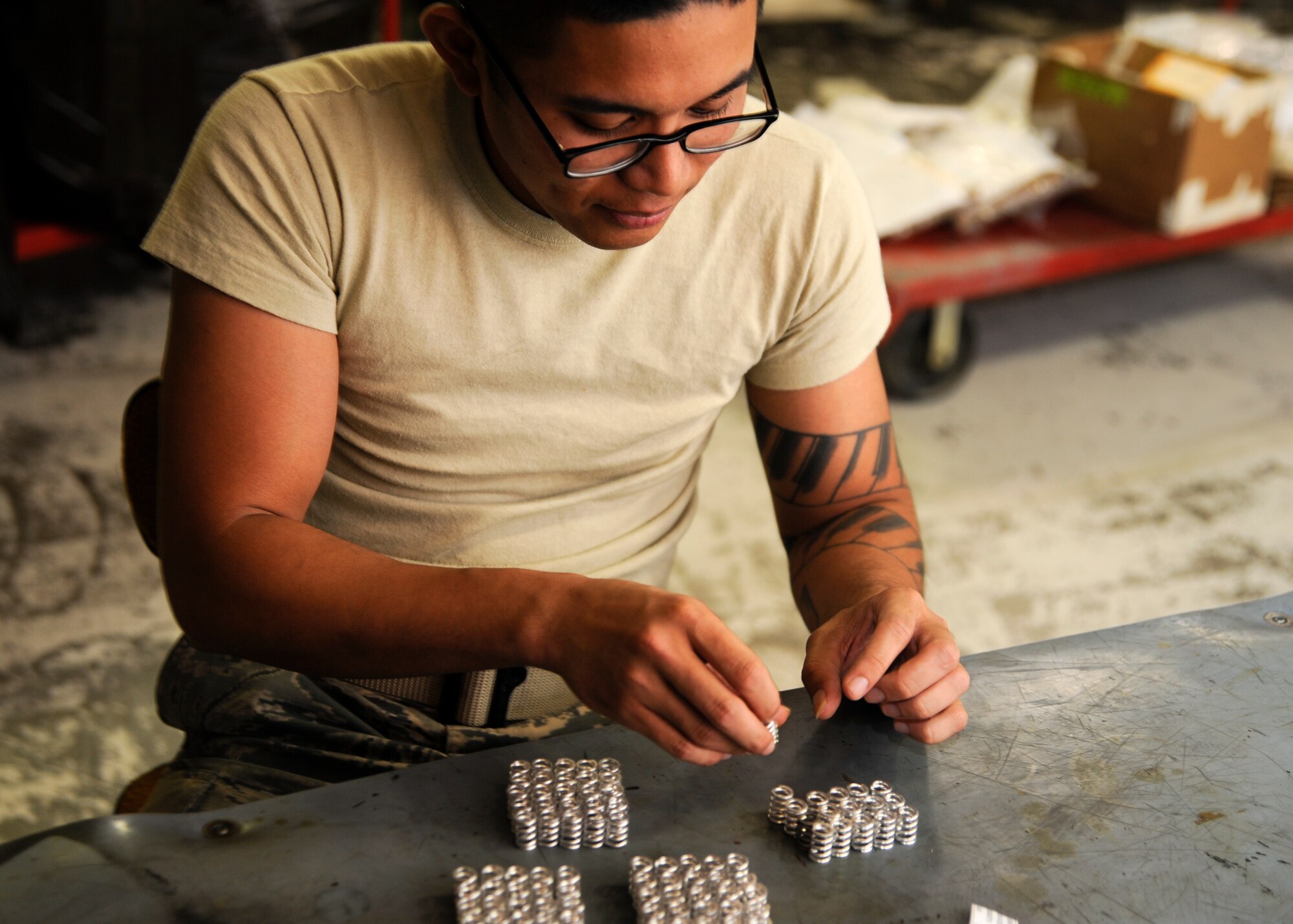 Senior Airman Eric Lobina sorts through hardware to turn-in to the supply warehouse at the 379th Air Expeditionary Wing in Southwest Asia, Oct 7, 2013. As the 379th Expeditionary Maintenance Squadron propeller centralized repair facility closes up shop, all spare hardware must be accounted for and, if serviceable, returned to base supply. Lobina is a 379th EMXS propeller CRF aerospace propulsion journeyman deployed from Little Rock Air Force Base, Ark., and an Orlando, Fla., native. (U.S. Air Force photo/Senior Airman Bahja J. Jones) 