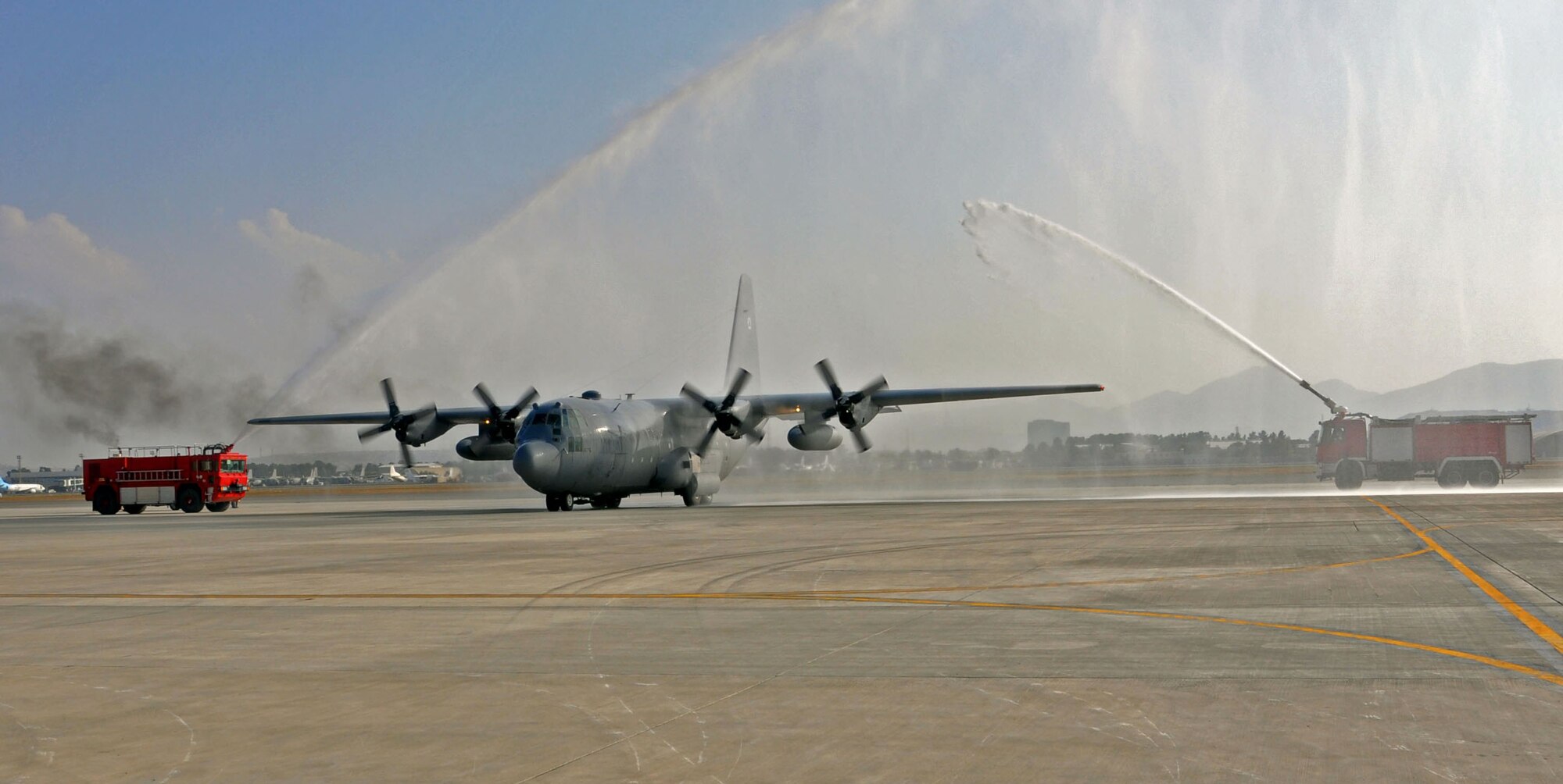 An Afghan Air Force C-130 taxis onto the ramp under celebratory streams of water during a ceremony Oct. 9, 2013 at Kabul International Airport, Afghanistan. This plane is one of two newly delivered C-130H models to the AAF. With the addition of the C-130 to the inventory, the AAF now has six different aircraft, which offer a wide variety of capabilities. The aircraft provides medium airlift capabilities, allowing for better range as well as increased passenger and cargo movement. The C-130H can cross the entirety of Afghanistan without refueling and can carry 10 times the amount of cargo of a Cessna 208, another aircraft in the AAF inventory. (U.S. Air Force photo/Capt. Anastasia Wasem)