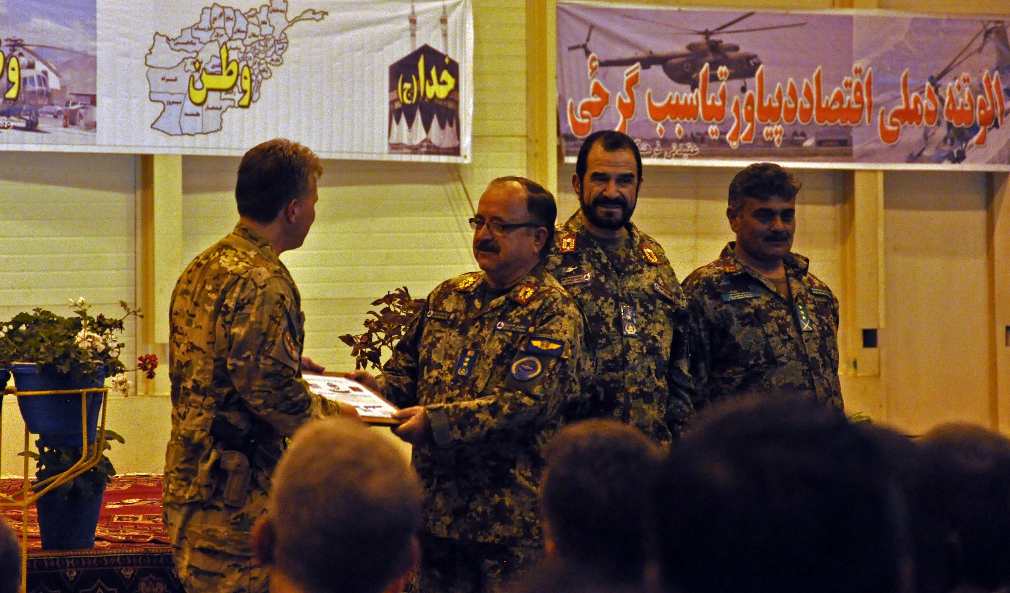Afghan Air Force Maj. Gen. Abdul Wahab Wardak, AAF commander, accepts two C-130 aircraft from Brig. Gen. John Michel, NATO Air Training Command-Afghanistan commander, during a ceremony Oct. 9, 2013 at Kabul International Airport, Afghanistan. With the addition of the C-130 to the inventory, the AAF now has six different aircraft, which offer a wide variety of capabilities. The aircraft provides medium airlift capabilities, allowing for better range as well as increased passenger and cargo movement. The C-130H can cross the entirety of Afghanistan without refueling and can carry 10 times the amount of cargo of a Cessna 208, another aircraft in the AAF inventory. (U.S. Air Force photo/Staff Sgt. Torri Ingalsbe)