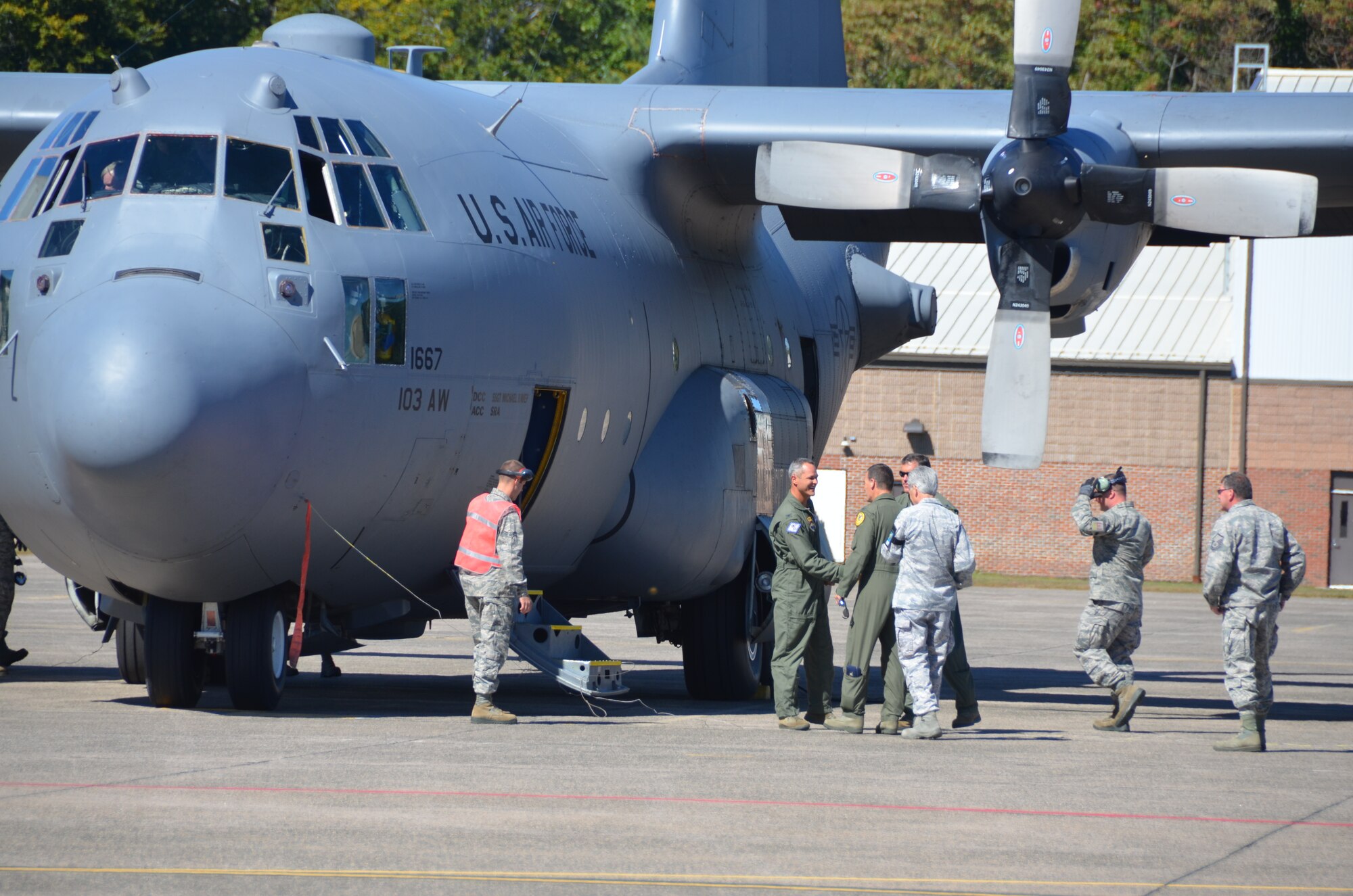 Airmen of the 103rd Airlift Wing welcome the first of eight C-130H aircraft expected to be assigned to the Connecticut Air National Guard moments after it touched down at Bradley International Airport, Windsor Locks, Conn., Tuesday, Sept. 24, 2013. (U.S. Air National Guard photo by Maj. Jefferson Heiland)