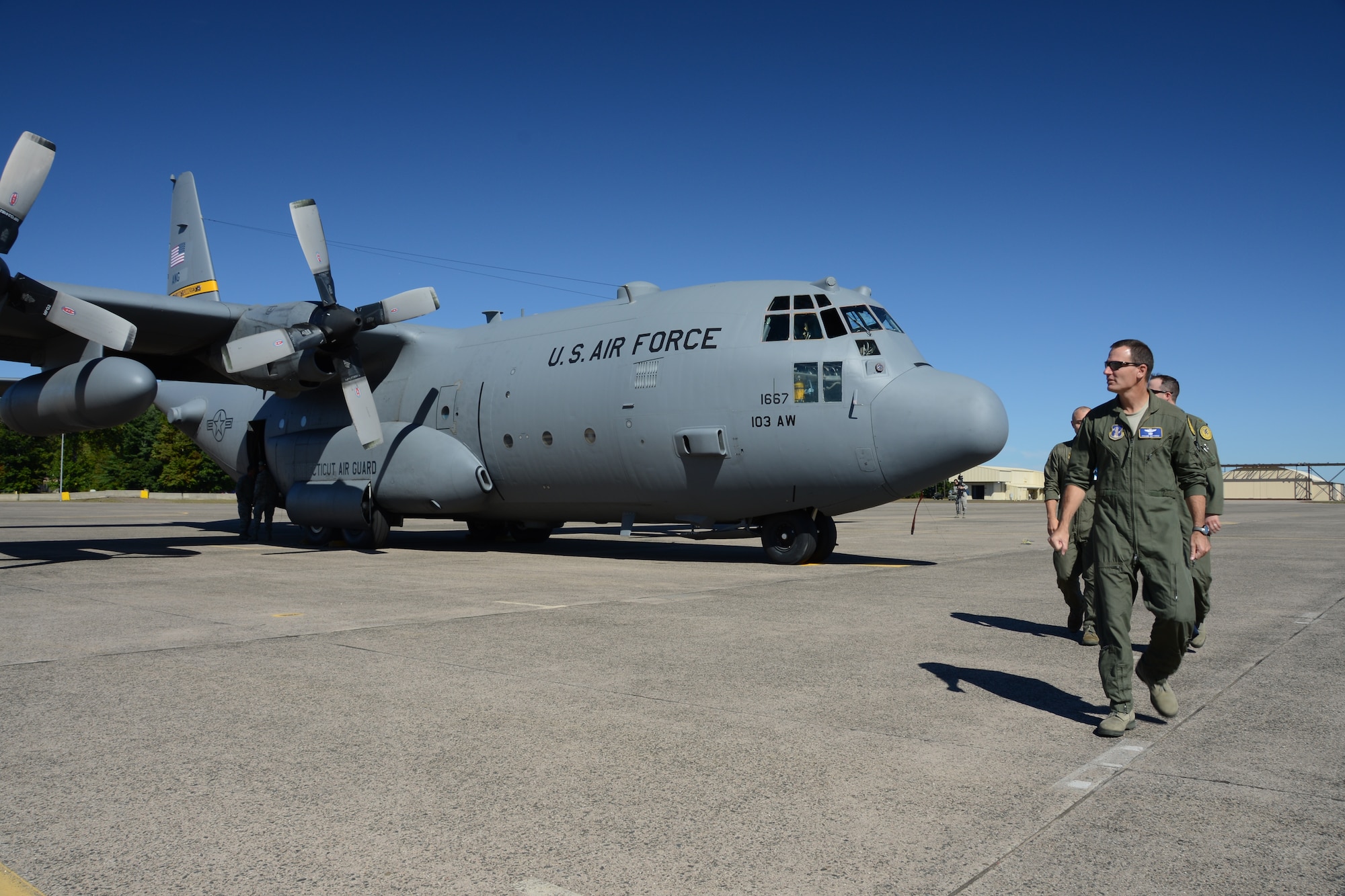 Col. Frank Detorie, commander of the 103rd Airlift Wing, looks back at the first of eight C-130H aircraft expected to be assigned to the Connecticut Air National Guard’s 103rd Airlift Wing after inspecting the aircraft shortly after it touched down at Bradley International Airport, Windsor Locks, Conn., Tuesday, Sept. 24, 2013. (U.S. Air National Guard photo by Master Sgt. Erin McNamara)
