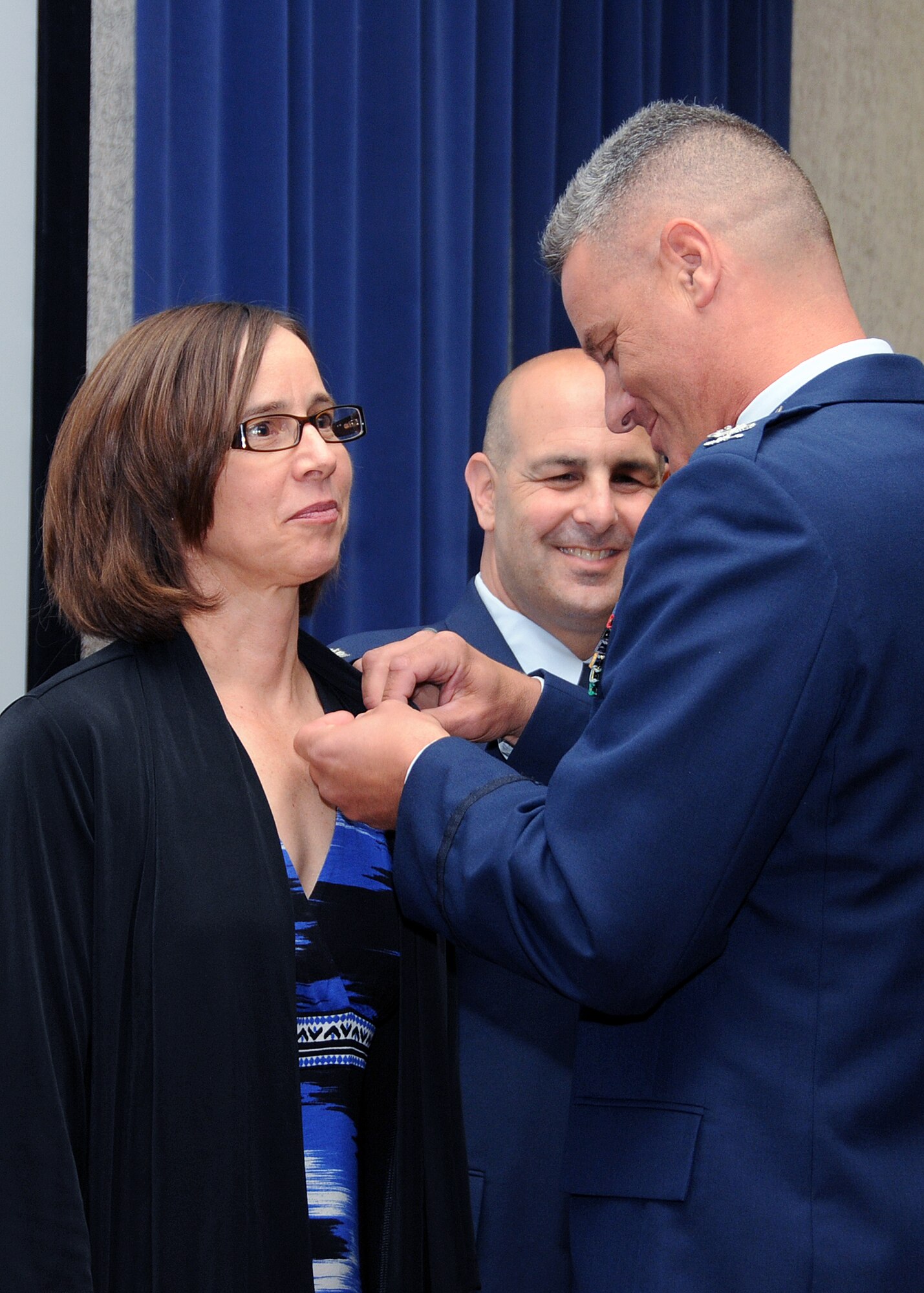 Mrs. Carol Hamel, wife of Colonel Anthony Hamel, Commander, 143d Mission Support Group, is pinned to Brigadier General in the Unorganized Rhode Island Militia following Col Hamel's promotion to Colonel. This is a long standing tradition done to remind Col Hamel of his position in the home. National Guard photo by Master Sgt Janeen Miller