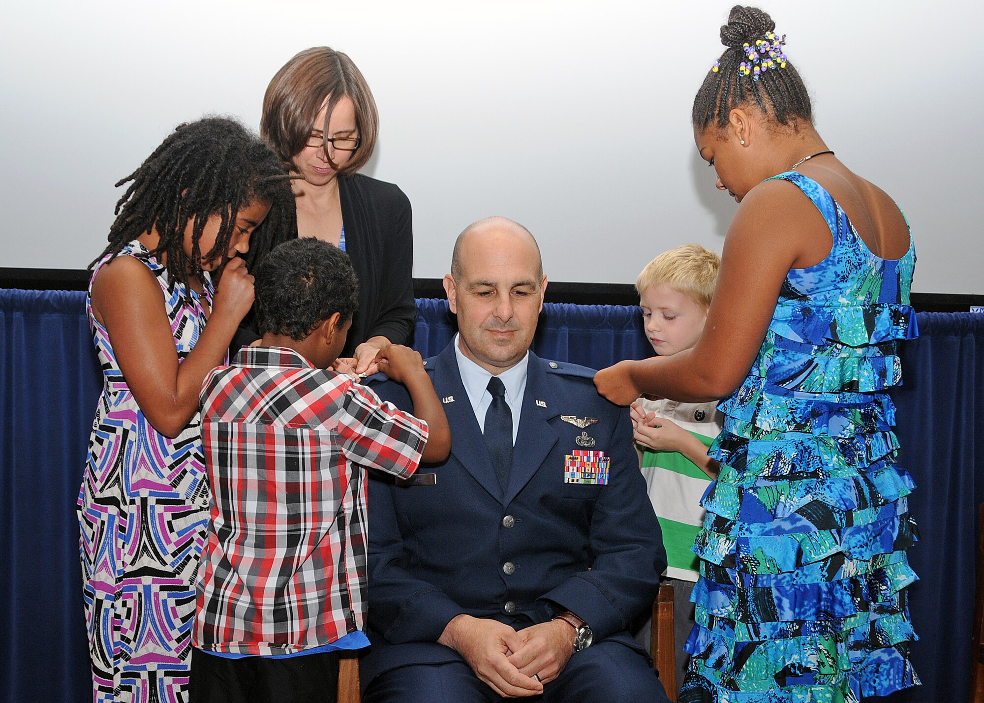 Colonel Anthony Hamel is pinned by his wife Carol and his children Sophia, Grace, Antonio and Andrew. National Guard photo by Master Sgt Janeen Miller
