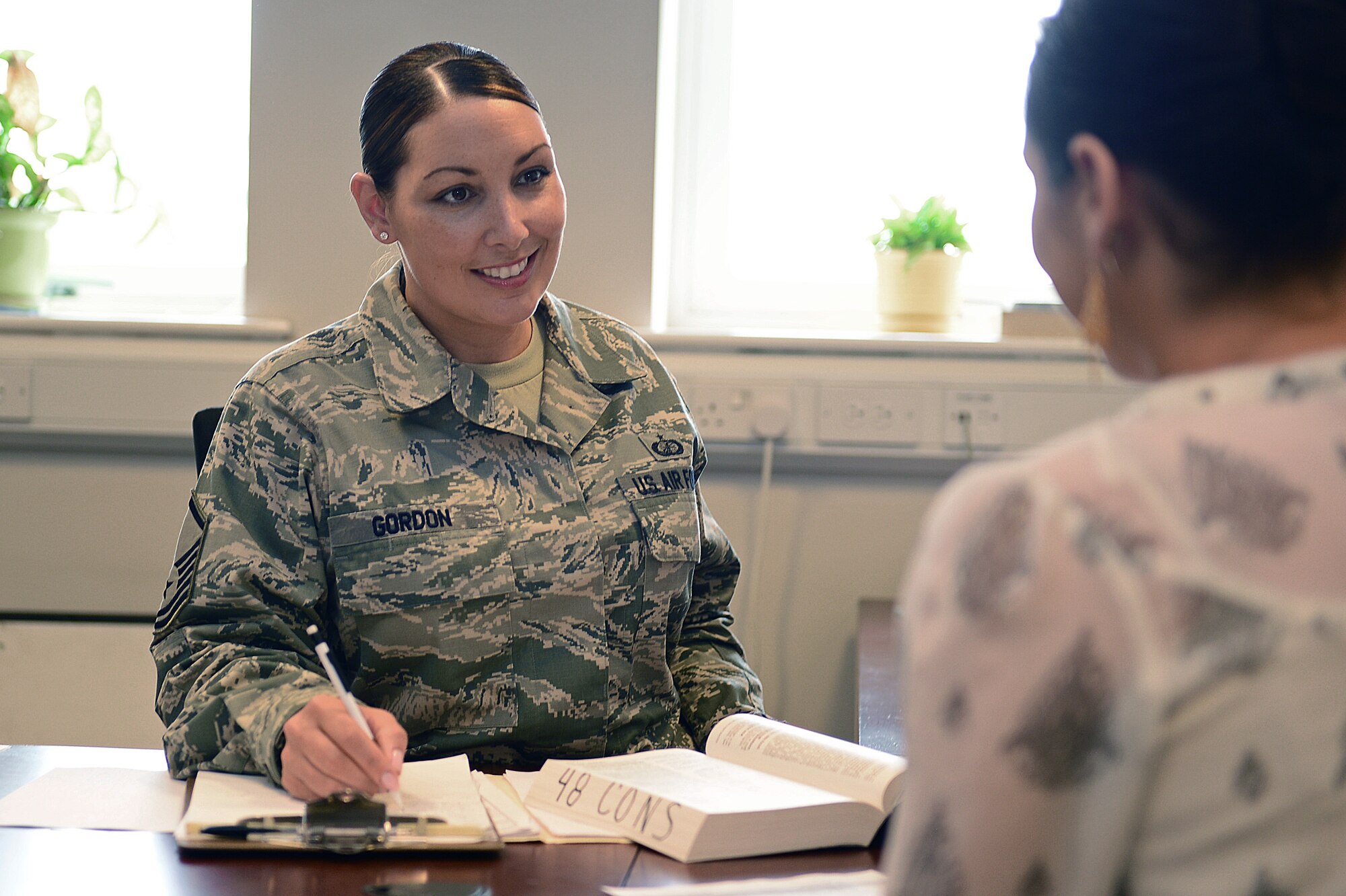 Master Sgt. Sarah Gordon, 48th Contracting Squadron, contract administrator, reviews contracts with a customer, at Royal Air Force Lakenheath, England, Oct. 8, 2013. Gordon was nominated for a Liberty Spotlight because she displays the core value of Service Before Self. (U.S. Air Force photo by Airman 1st Class Dawn M. Weber/Released)  