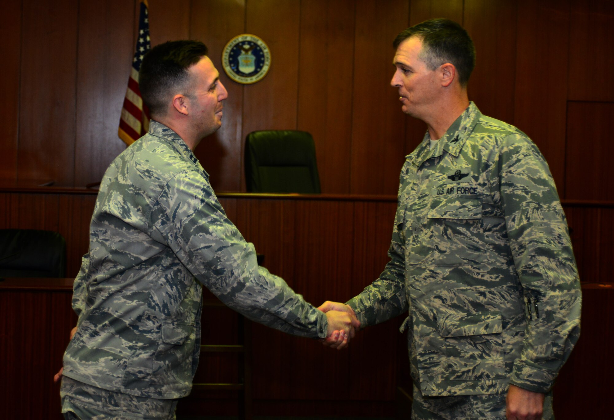 Capt. Ian Duggan, 39th Air Base Wing Judge Advocate chief of military justice, receives a coin from Col. Craig Wills, 39th Air Base Wing commander, Oct. 9, 2013, Incirlik Air Base, at Turkey. "Pick of the 'Lik’" recognizes outstanding members of Team Incirlik who display a commitment to excellence. Airmen are nominated by their squadron supervision and selected by 39th Air Base Wing senior leadership for recognition. (U.S. Air Force photo by Staff Sgt. Eric Summers Jr./Released)