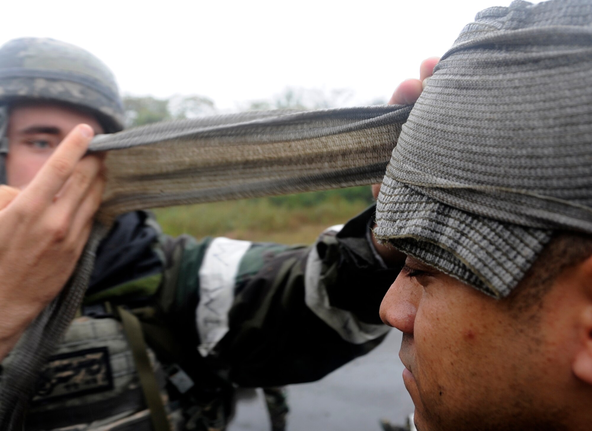 Staff Sgt. James Greuel, left, and Tech. Sgt. Aaron Watkins, 35th Security Forces Squadron patrolmen, participate in self-aid and buddy care training during an Operational Readiness Exercise at Misawa Air Base, Japan, Oct. 9, 2013. In a deployed environment, SFS Airmen are trained to provide self-aid and buddy care while under enemy fire. (U.S. Air Force photo by Airman 1st Class Kaleb Snay)