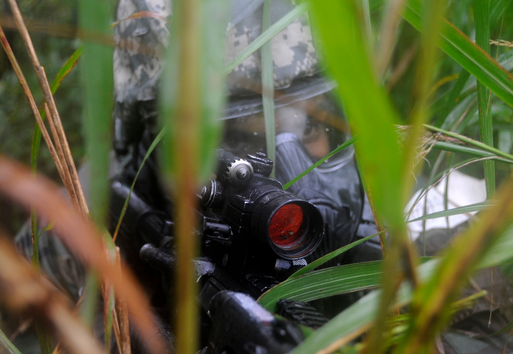 Staff Sgt. Eugene Telfair, 35th Security Forces Squadron NCO in charge of corrections, takes cover during an Operational Readiness Exercise at Misawa Air Base, Japan, Oct. 9, 2013. Base defenders were tested on their ability to survive and operate while on patrol or defending a base in a deployed environment. (U.S. Air Force photo by Airman 1st Class Kaleb Snay)
