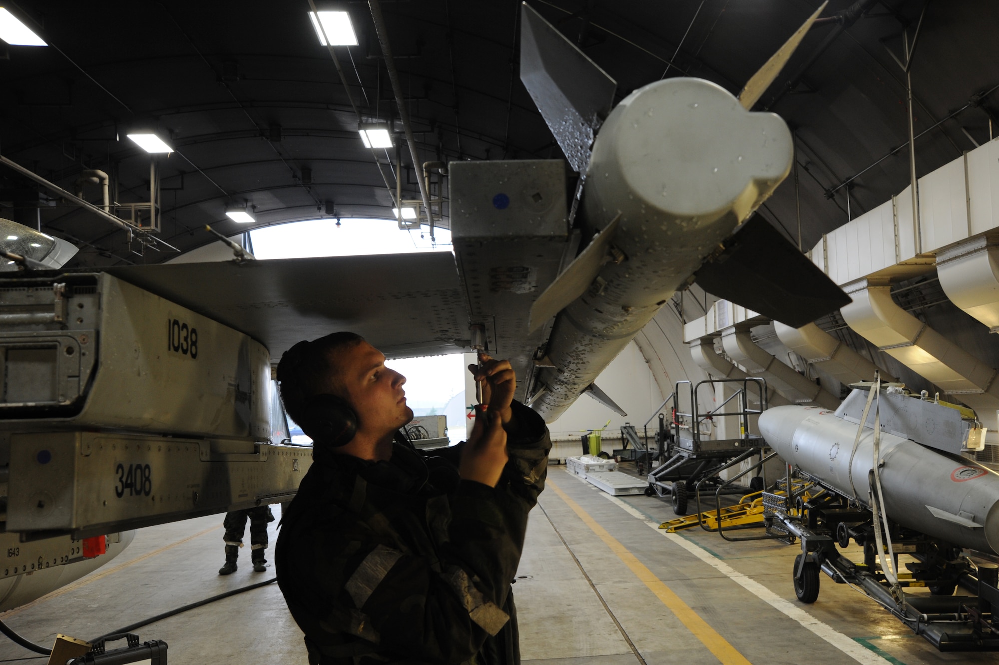 Senior Airman Eric Lane, 14th Aircraft Maintenance Unit, performs maintenance on an F-16 Fighting Falcon at Misawa Air Base, Japan, Oct. 9, 2013. The maintenance was required as part of a weeklong Operational Readiness Exercise that tested the maintainers ability to repair aircraft and get them airborne in short turnaround times. (U.S. Air Force photo by Senior Airman Derek VanHorn)