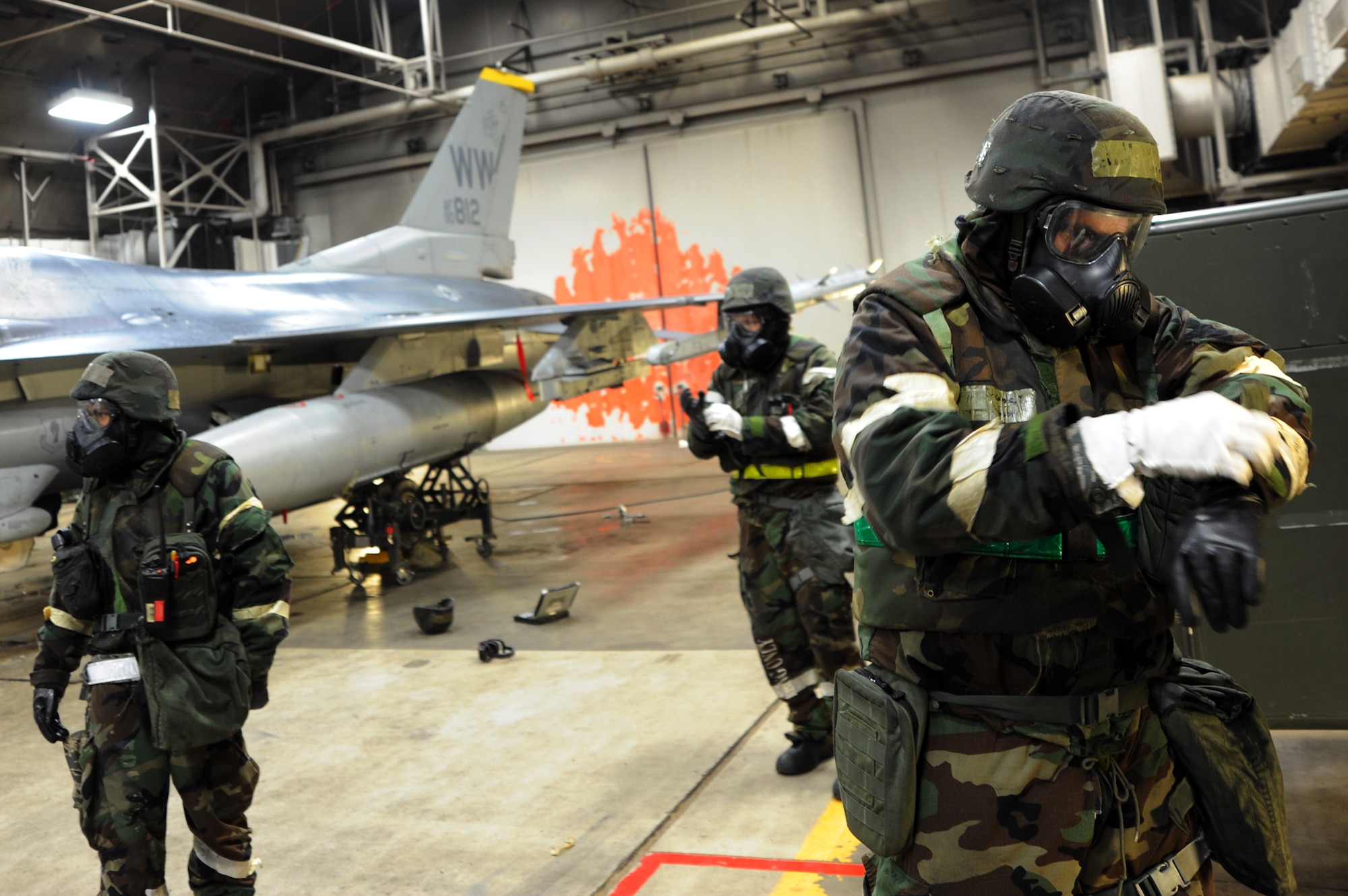Maintainers from the 35th Maintenance Group don mission orientation protective posture gear during a weeklong Operational Readiness Exercise at Misawa Air Base, Japan, Oct. 9, 2013. The 35th Fighter Wing Inspection Team implemented various injects that forced maintainers to react on the fly to repair F-16 Fighting Falcons throughout the week. (U. S. Air Force photo by Senior Airman Derek VanHorn)