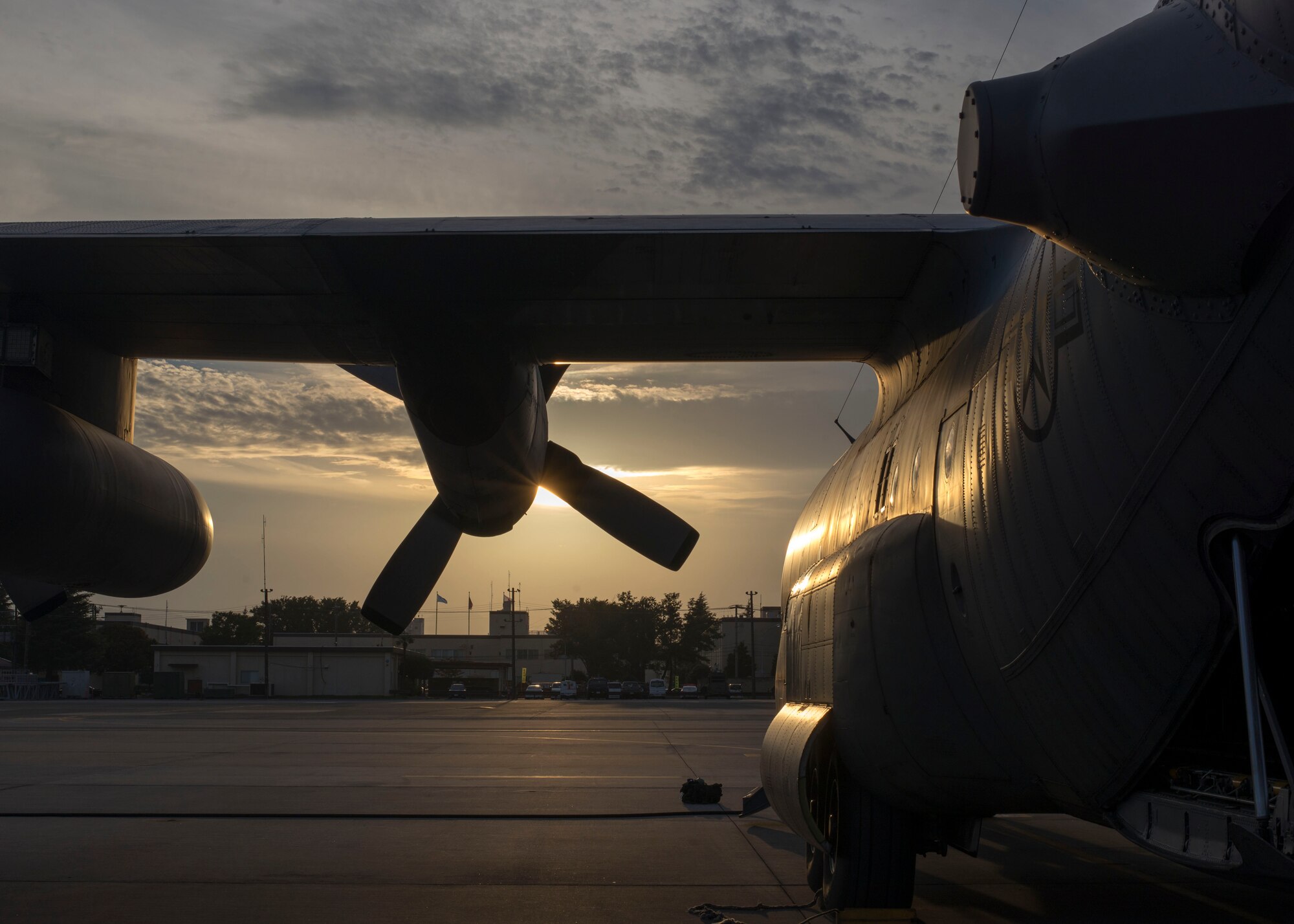 A C-130 Hercules faces the setting sun after a successful training flight during Readiness Week at Yokota Air Base, Japan, Oct. 8, 2013. As the Western Pacific air mobility hub, Yokota is postured to respond to contingencies throughout the region. (U.S. Air Force photo by Captain Raymond Geoffroy/Released)