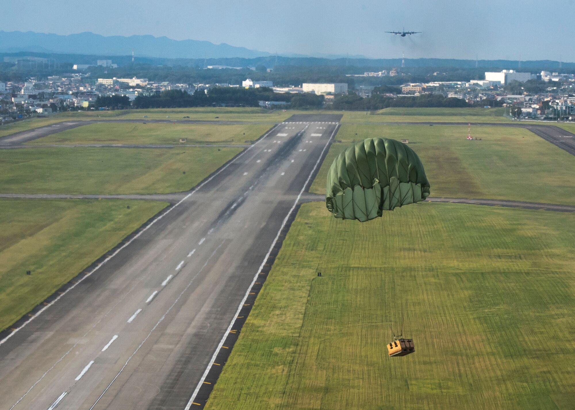 A low-cost, low-altitude airdrop descends toward a landing zone during a training flight as part of Readiness Week at Yokota Air Base, Japan, Oct. 8, 2013. Readiness week is designed to help Yokota Airmen hone their skills through a series of training scenarios events and exercises. (U.S. Air Force photo by Captain Raymond Geoffroy/Released)