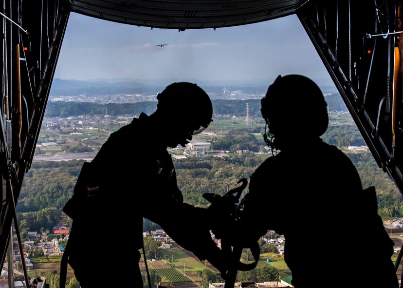 Tech. Sgt. Todd Bergin and Airman 1st Class Andrew Fox, 36th Airlift Squadron loadmasters, prepare to drop a low-cost, low-altitude airdrop package during a training flight as part of Readiness Week at Yokota Air Base, Japan, Oct. 8, 2013. Readiness week is focused on a number of mission related tasks that enhance the wing’s ability to perform its mission under various conditions. (U.S. Air Force photo by Captain Raymond Geoffroy/Released)
