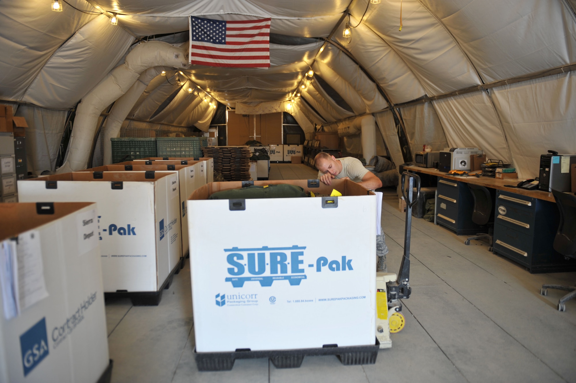 Staff Sgt. Kyle Deconnick completes paperwork on returned items at the 379th Air Expeditionary Wing in Southwest Asia, Oct. 7, 2013. The Expeditionary Theater Distribution Center return tent receives items issued to members returning from deployments and joint expeditionary taskings. Deconnick is the 379th Expeditionary Logistics Readiness Squadron return facility Assistant NCO in charge deployed from Dover AFB, Del., and a Columbus, Ohio, native. (U.S. Air Force photo/Master Sgt. David Miller)