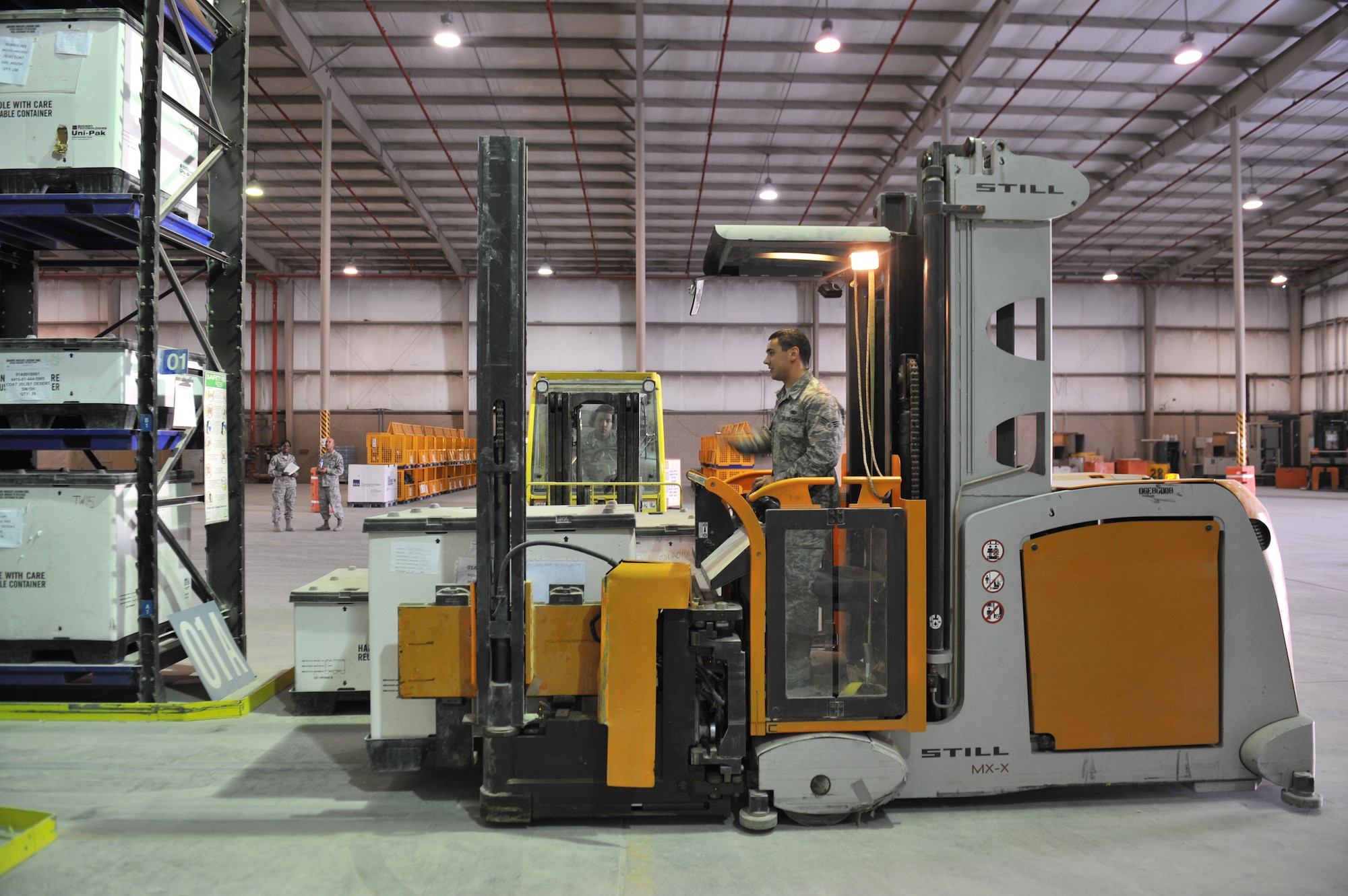 Senior Airmen Jacob Juarez and Earl Jefferson operate forklifts to move inventory items at the 379th Air Expeditionary Wing in Southwest Asia, Oct. 7, 2013. The Expeditionary Theater Distribution Center warehouse has nearly 420 line items supporting Operation Enduring Freedom and Combined Joint Task Force-Horn of Africa operations. Juarez is a 379th Expeditionary Logistics Readiness Squadron warehouse customer service journeyman deployed from Fairchild Air Force Base, Wash., and a Thornton, Colo., native. Jefferson is a 379th Expeditionary Logistics Readiness Squadron warehouse journeyman deployed from Travis Air Force Base, Calif., and a Fort Lewis, Wash., native. (U.S. Air Force photo/Master Sgt. David Miller)