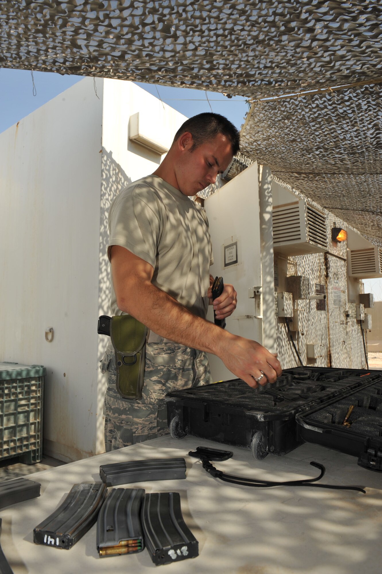 Senior Airman Matthew Coffman loads ammunition into magazines at the 379th Air Expeditionary Wing in Southwest Asia, Oct. 7, 2013. The Expeditionary Theater Distribution Center transient armory stores weapons for transient personnel. Coffman is a 379th Expeditionary Logistics Readiness Squadron transient armory technician deployed from Minot Air Force Base, N.D., and a Detroit, native. (U.S. Air Force photo/Master Sgt. David Miller)