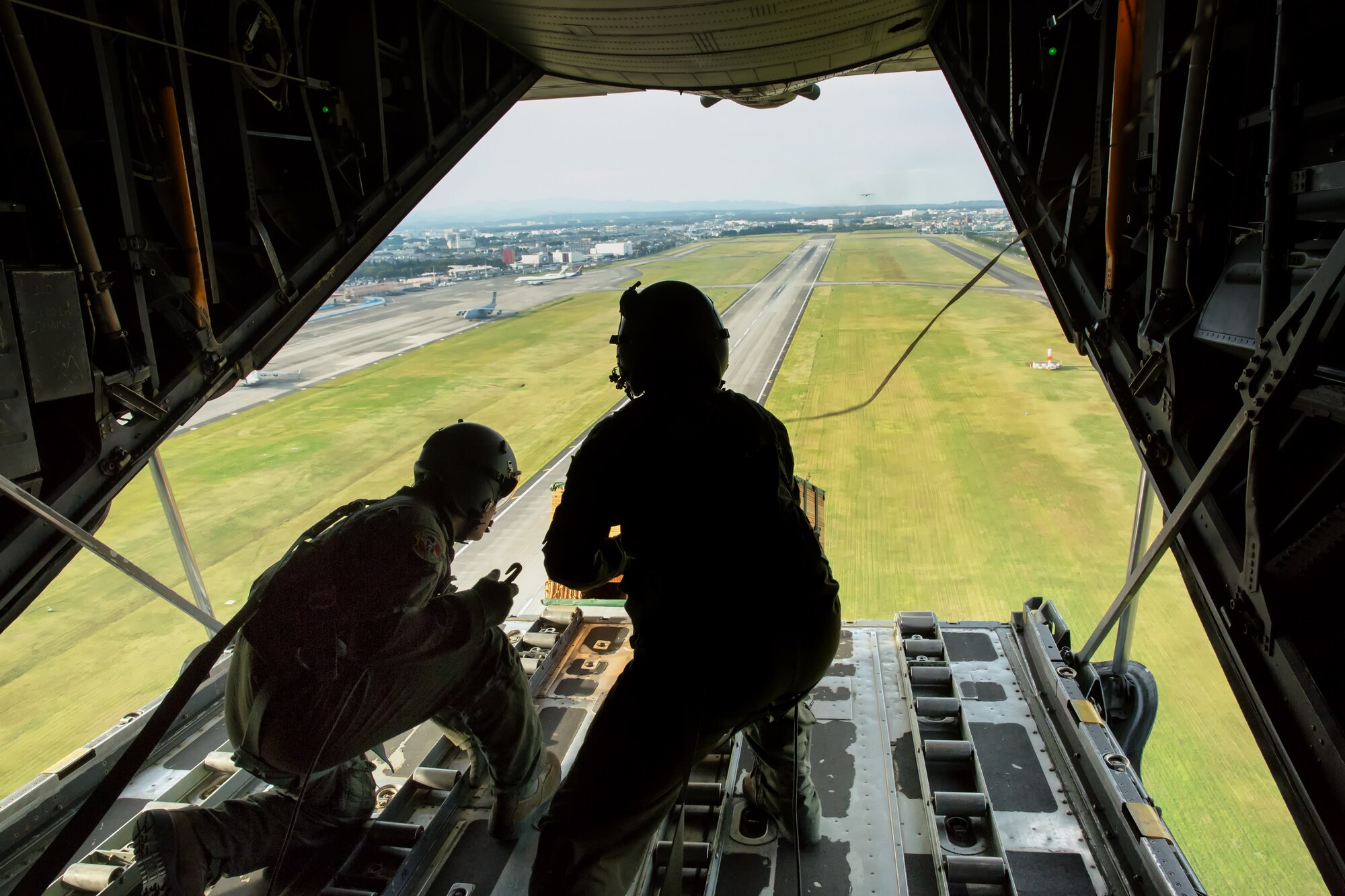 (From left to right) Airman 1st Class Andrew Fox and Tech. Sgt. Todd Bergin, loadmasters assigned to the 36th Airlift Squadron, deploy a low-cost, low-altitude payload during a Readiness Week training mission over Yokota Air Base, Japan, Oct. 8, 2013. Readiness Week focuses on Yokota's professional airlift mission and developing Airmen's ability to support any contingency in the Pacific.  (U.S. Air Force photo by Osakabe Yasuo/Released)
