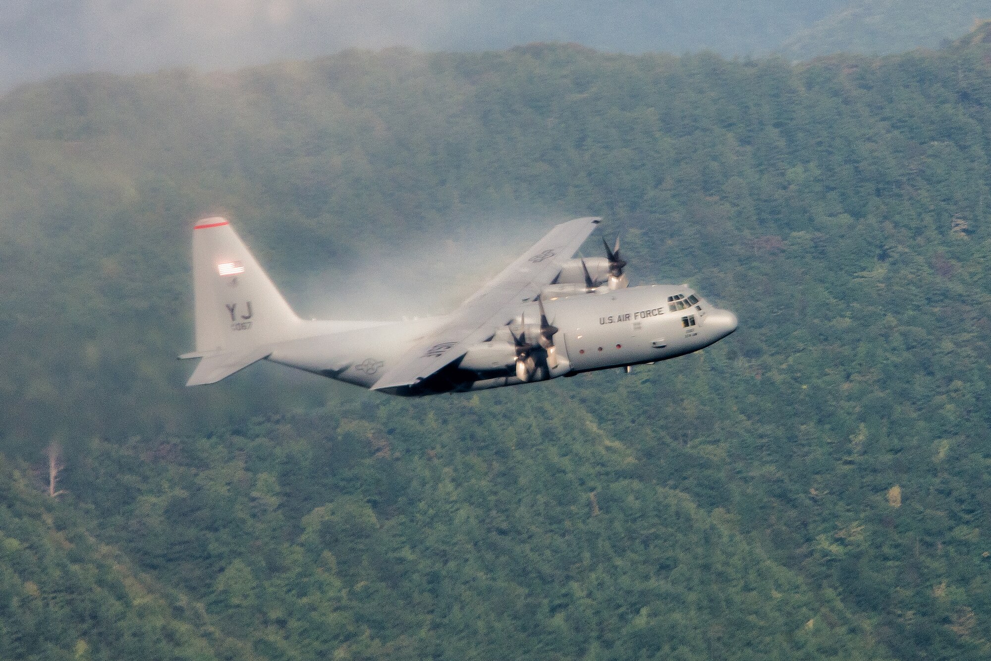 A C-130 Hercules conducts a tactical training mission in a mountain range near Yokota Air Base, Japan, during Readiness Week Oct. 8, 2013. Readiness Week focuses on Yokota's professional airlift mission and developing Airmen's ability to support any contingency in the Pacific. (U.S. Air Force photo by Osakabe Yasuo/Released)