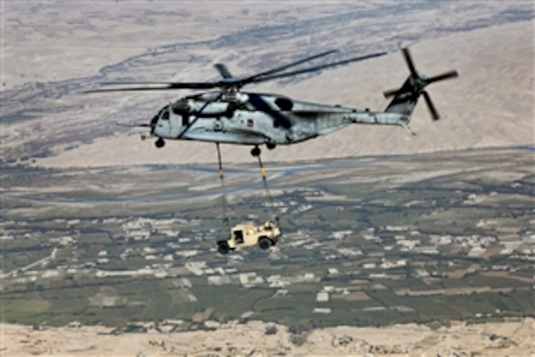 A CH-53E Super Stallion helicopter transports a high-mobility, multipurpose vehicle over Helmand province, Afghanistan, Oct. 7, 2013. The Stallion is assigned to Marine Heavy Helicopter Squadron 462, which conducted the mission as part of demilitarization.
