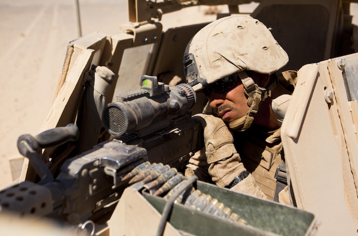 Lance Cpl. Kevin Dunseith, a Blue Point, N.Y., native and turret gunner with Combat Logistics Regiment 2, Regional Command (Southwest), crews his machine gun during a combat logistics patrol in Helmand province, Afghanistan, Oct. 1, 2013. Dunseith stood in the turret for hours watching for possible threats during a four-day mission to Camp Dwyer, Afghanistan.