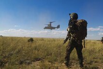 A U.S. Marine with Marine Special Operations Battalion (MSOB) waits for a Marine Vessel-22B Osprey to land near Coloardo Springs Colo., Sept. 27, 2013. The purpose of the joint exercise was to test the fleet readiness of the bi-annual update to the MV-22B's software. 