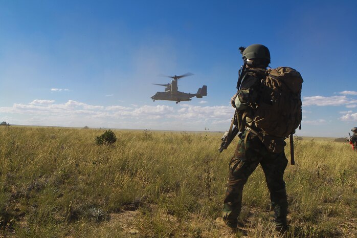 A U.S. Marine with Marine Special Operations Battalion (MSOB) waits for a Marine Vessel-22B Osprey to land near Coloardo Springs Colo., Sept. 27, 2013. The purpose of the joint exercise was to test the fleet readiness of the bi-annual update to the MV-22B's software. 