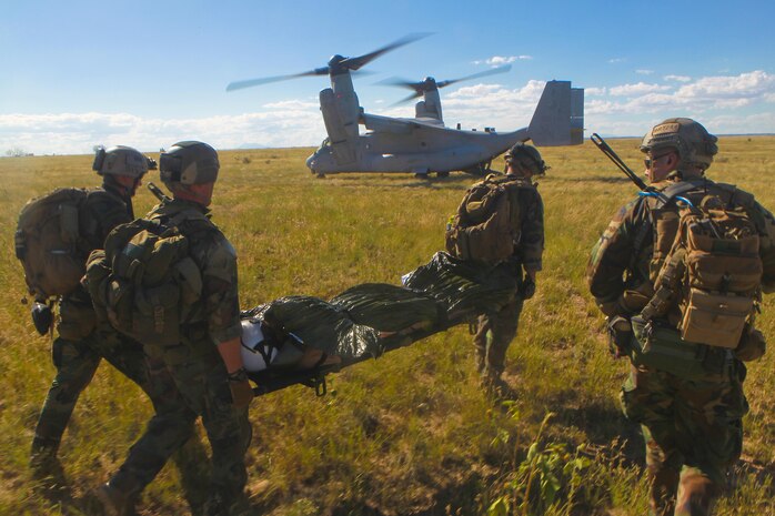 U.S. Marines fron 2nd Marine Special Operations Battalion (MSOB) extract U.S. Navy Lieutenant Commander Tim Welsh during a Tactial Recovery of Aircraft Personnel exercise near Coloardo Springs, Colo. Sept. 21, 2013. The purpose of this exercise was to test the fleet readiness of the Marine Vessel-22B's bi-annual software update. 