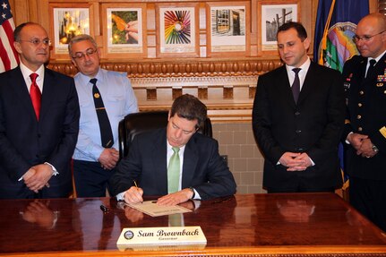 Kansas Gov. Sam Brownback signs a proclamation reaffirming the commitment to the relationship between the people of the state of Kansas and the Republic of Armenia, March, 20, 2012 after hosting a luncheon for Seyran Ohanyan, the Minister of Defense for the Republic of Armenia, at the governor's residence to honor the minister's visit.