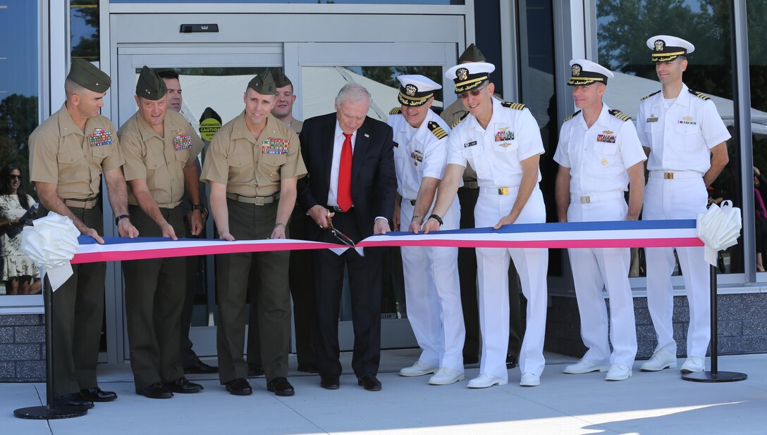 Arnold Fisher, the honorary chairman for the Intrepid Fallen Heroes Fund, cuts the ribbon marking the official opening of the Intrepid Spirit Concussion Recovery Center aboard Marine Corps Base Camp Lejeune, Oct. 2. The center, named Intrepid Spirit, is the primary clinic to diagnose and treat Marines and sailors with Traumatic Brain Injury in the Camp Lejeune area. The Intrepid Spirit team has treated more than 150 patients since its doors opened in August and anticipates treating more than 1,000 active-duty Marines and sailors within the year using a 16-week interdisciplinary approach that includes a combination of traditional and adjunct therapies and incorporates the service member’s family throughout the recovery process.