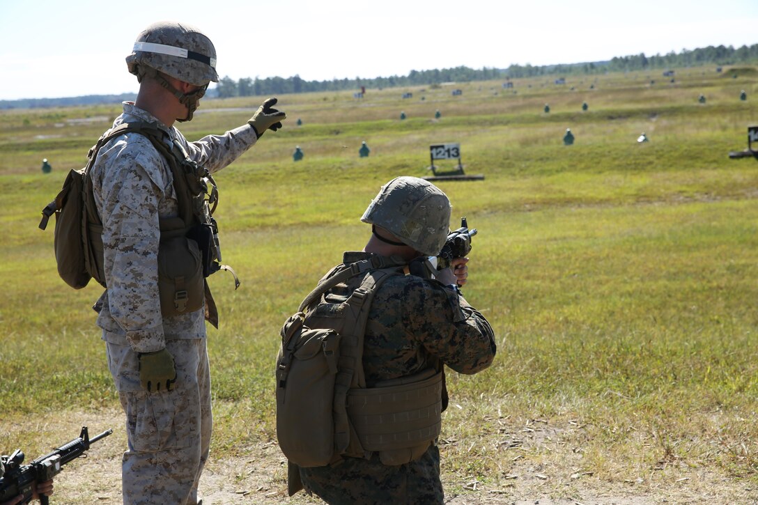 Sgt. Lane O. Crochet, a combat instructor with 2nd platoon, Company I., Marine Combat Training Battalion, advises Pfc. Nicholas S. Corrente, a Marine with 1st platoon where to shoot during the course during the unknown distance course of fire at Verona Loop Rifle Range, Oct. 1. The course’s targets range from 150 to 400 meters.