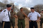 Army Sgt. Major Kamodi, noncommissioned officer in charge of the Botswana Defence Force Wildlife Training Center, explains to Army Maj. Gen. Greg Lusk, adjutant general of the North Carolina National Guard and Army Maj. Gen. Edward Leacock of the Defense Intelligence Agency, how they train BDF Soldiers to react to various predators to prepare Botswana soldiers to conduct patrols in the bush areas of the country in November 2011. The North Carolina National Guard and Botswana are partners through the National Guard State Partnership Program.