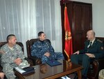Chief Petty Officer Roy Maddocks, U.S. European Command's Senior Enlisted Leader, and Command Sgt. Maj. Terrence Harris, senior enlisted leader of the Maine National Guard, discuss noncommissioned officer corps development with Colonel Zoran Lazarevic, chief of staff of the Montenegrin General Staff.