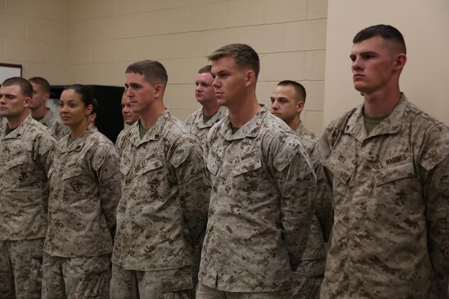 Cpl. Dominick W. Phillips (center left) and Lance Cpl. Michael W. Tarbutton (center right), Marines who served with Sgt. Julian Bejarano Jr. in Afghanistan, stand in formation during Bejarano’s Purple Heart award ceremony  aboard Camp Lejeune, N.C., Oct. 8, 2013. Phillips and Tarbutton were on the convoy during which Bejarano was injured by an improvised explosive device blast in Helmand province, Afghanistan, July 5, 2013. 