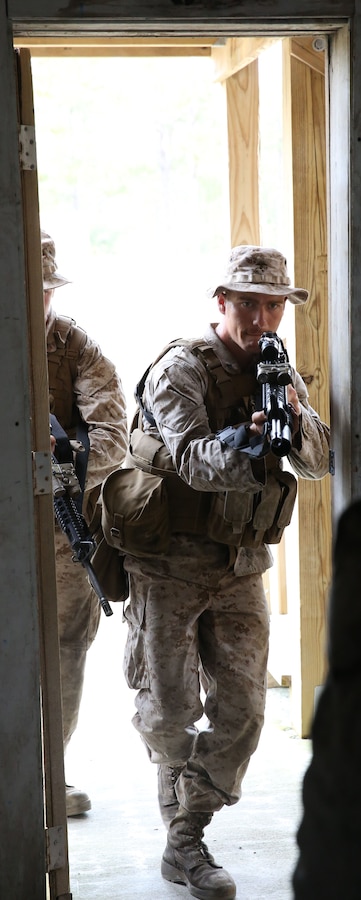 Corporal Justin Rea, an infantryman with Company C, 1st Battalion, 2nd Marine Regiment, 2nd Marine Division, rushes into a room to clear the building during military operations in urban terrain training aboard Marine Corps Base Camp Lejeune Oct. 7, 2013. First Battalion, 2nd Marines held a battalion-level field exercise Sept. 28 – Oct. 9, marking the first battalion-size training event since December 2012.