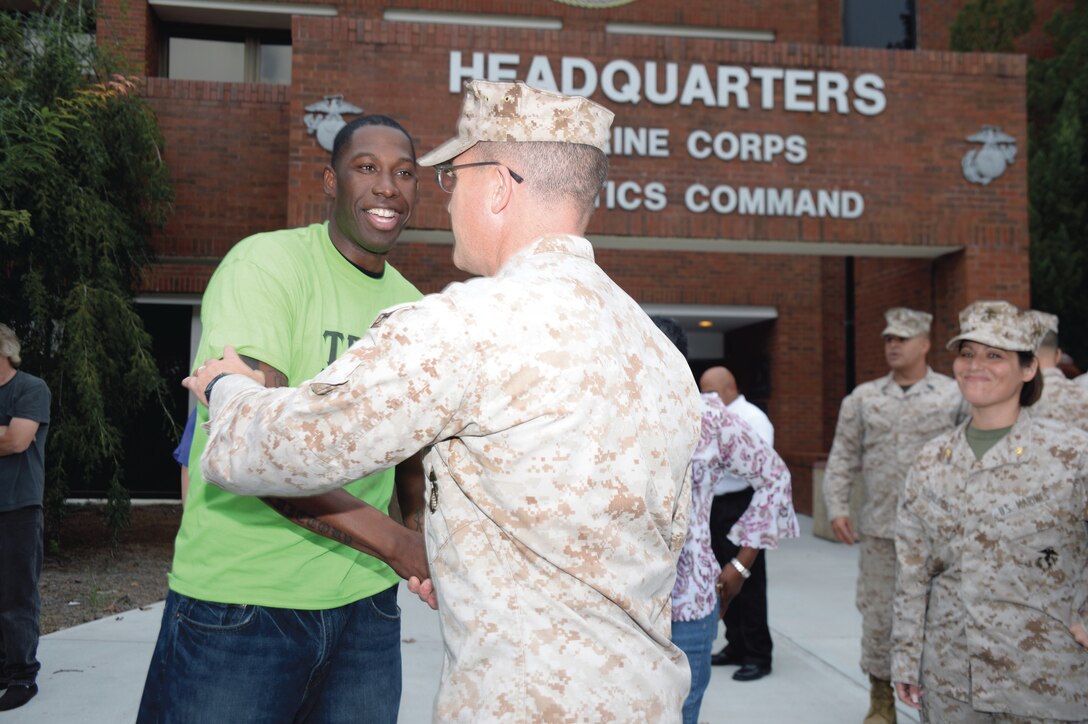 Staff Sgt. Tony Robinson, left, shakes hands with Col. Yori Escalante, chief of staff, Marine Corps Logistics Command, Sept. 24. Six Marines returned from the Middle East region following a roughly six-month deployment.