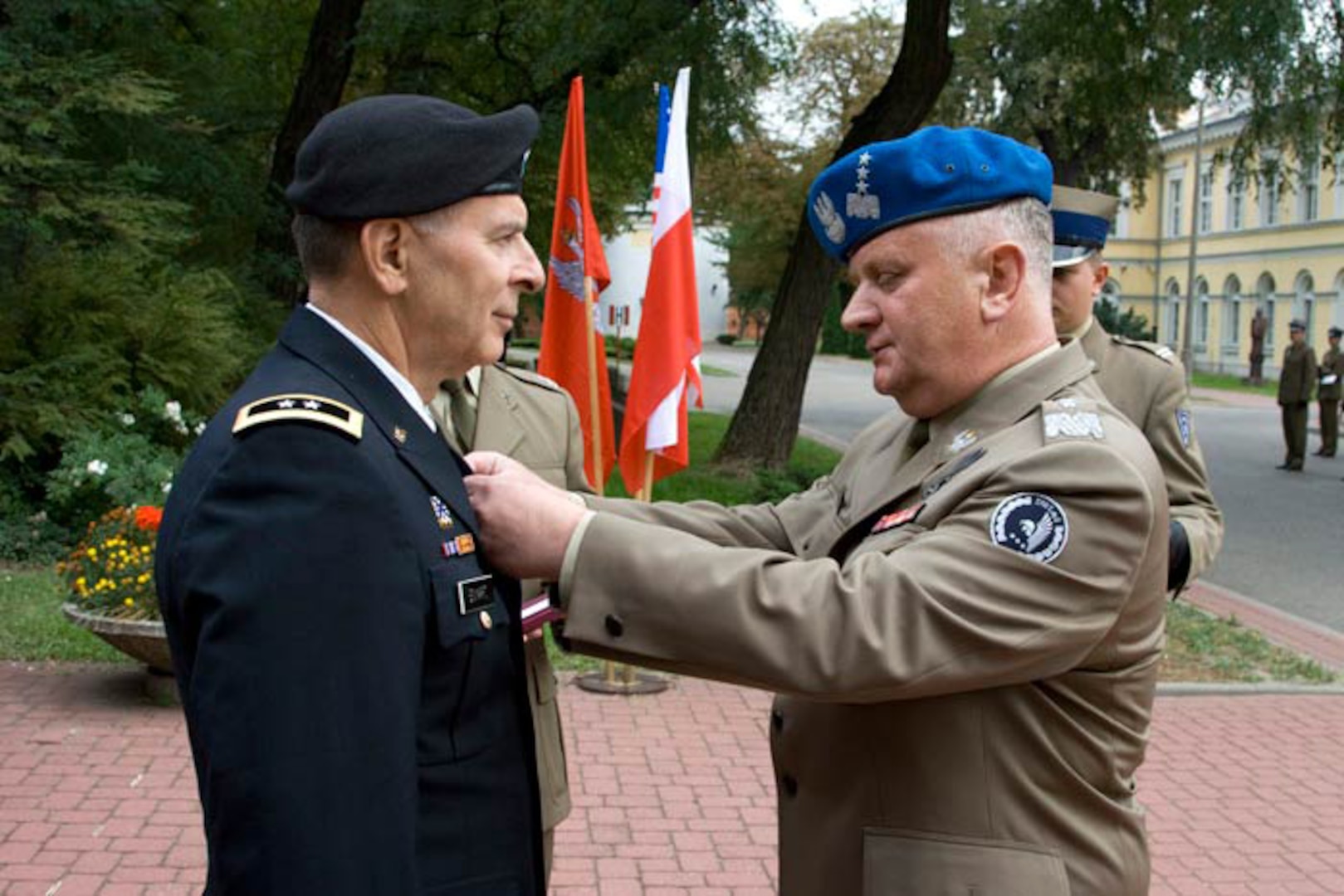 Army Maj. Gen. William Enyart, the adjutant general of the Illinois National Guard, receives the Polish Army Medal from Polish Land Forces Commander Lieutenant General Zbigniew Glowienka on Sept. 23. 2011. The Illinois National Guard and Poland have been partners through the National Guard State Partnership Program since 1993.