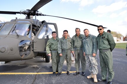 The member of the Kentucky Army National Guard 63rd Theater Aviation Brigade stands with the members of the Ecuadorian Army Air Group during their visit at Boone National Guard Center in Frankfort, Ky., Nov. 17, 2011. The Kentucky National Guard hosted a team of aviators and maintainers from the Republic of Ecuador Army Air Group as part of the National Guard State Partnership Program.