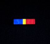 The Alaska National Guard State Partnership Program Ribbon is divided into three vertical sections of blue, gold and red, representing the significance of the partnership between Alaska and the Republic of Mongolia by representing the colors of each of their flags. The blue represents the eternal skies expanding above both nations, the red symbolizes progress and prosperity and the gold signifies wealth.