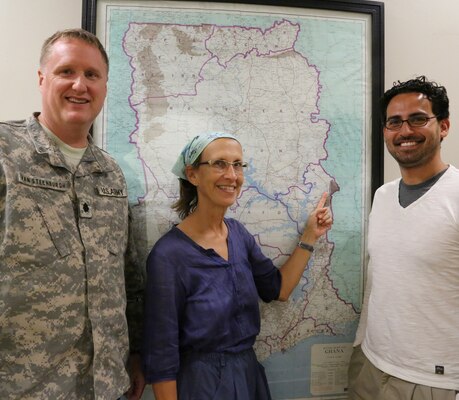 (From left) Lt. Col. John Van Steenburgh, Office of Security Cooperation Chief for Ghana, Togo and Benin; Linda Smittle, Peace Corps Ghana volunteer and Marcelo Maier, U.S. Army Corps of Engineers Europe District special projects engineer pause to point out the location of the Nkwanta Nutritional Rehabilitation Center project on a map of Ghana during a meeting at the embassy in Accra.




