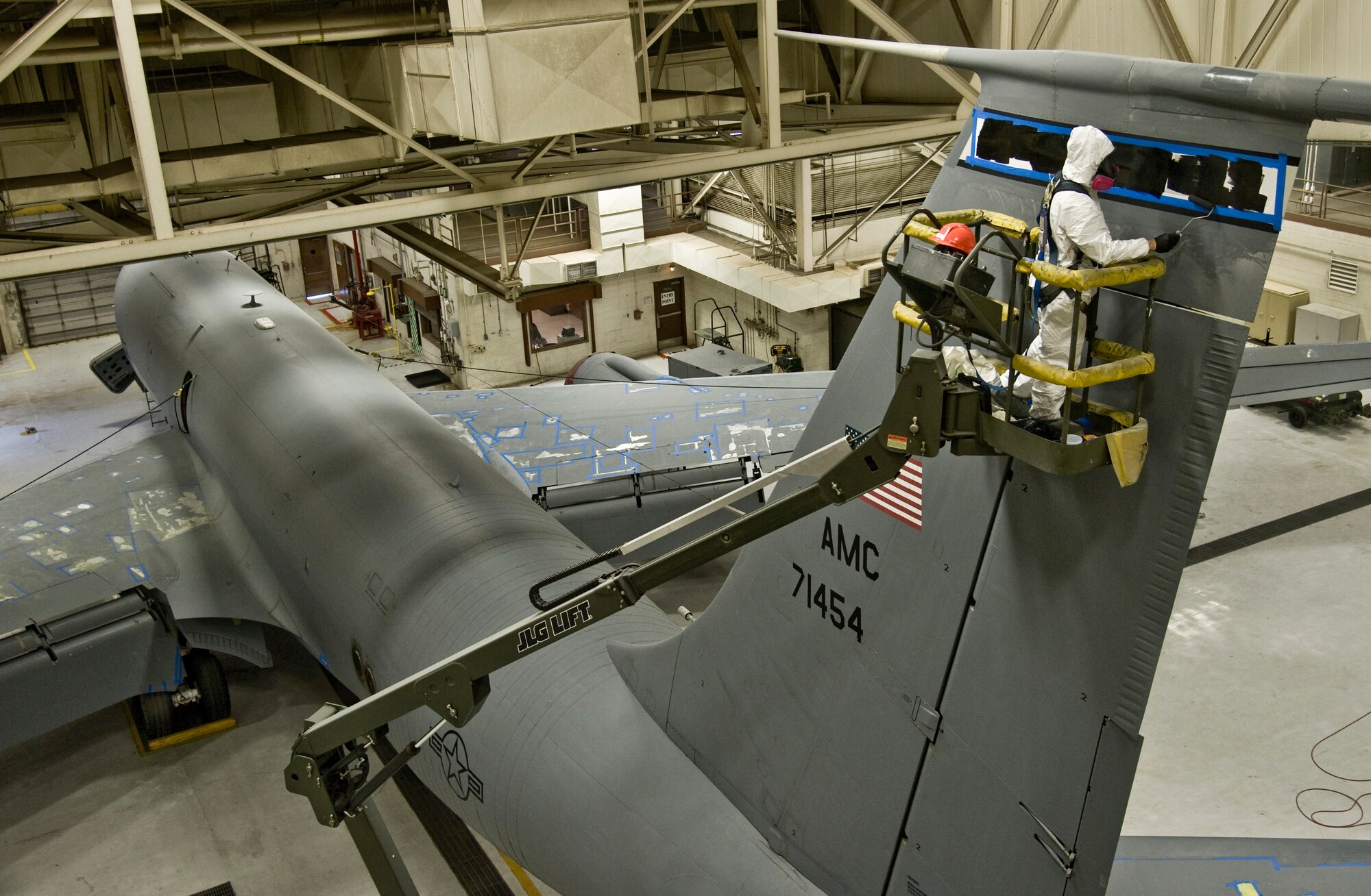Airman 1st Class Eric Amato, 22nd Maintenance Squadron aircraft structural maintenance journeyman, paints the McConnell insignia the vertical stabilizer of a KC-135 Stratotanker, Oct. 2, 2013, at McConnell Air Force Base, Kan. He wears personal protective equipment to protect himself from harmful paint fumes. (US Air Force photo/Airman 1st Class John Linzmeier)