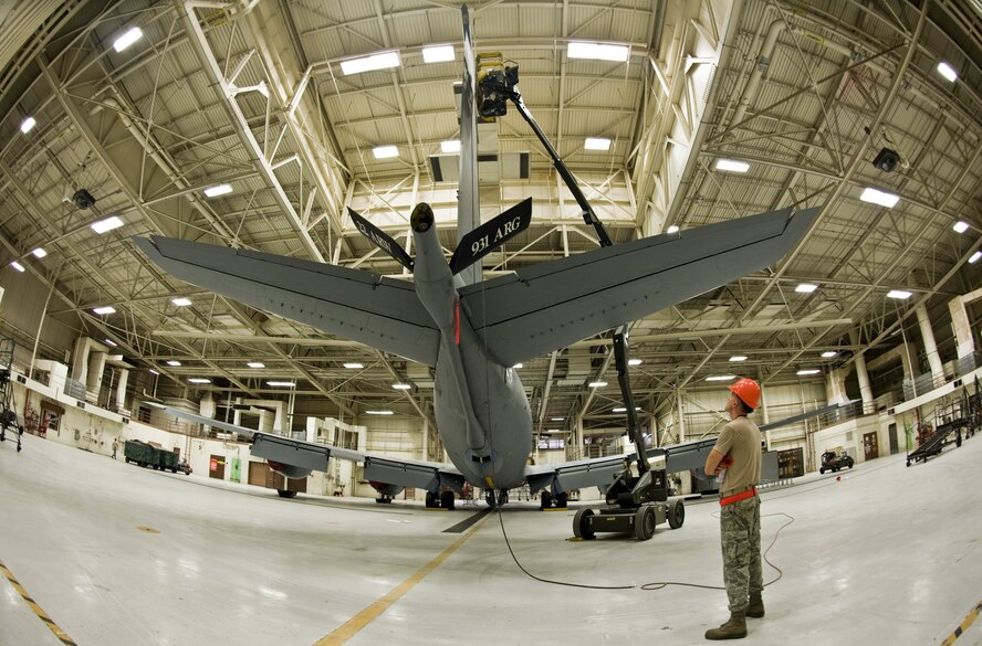 An Airman from the 22nd Maintenance Squadron observes his wingman who is preparing to paint the vertical stabilizer of a KC-135 Stratotanker, Oct. 2, 2013, at McConnell Air Force Base, Kan. A spotter purpose helps prevent the JLG operator from encountering a hazard or potential emergencies. (US Air Force photo/Airman 1st Class John Linzmeier)