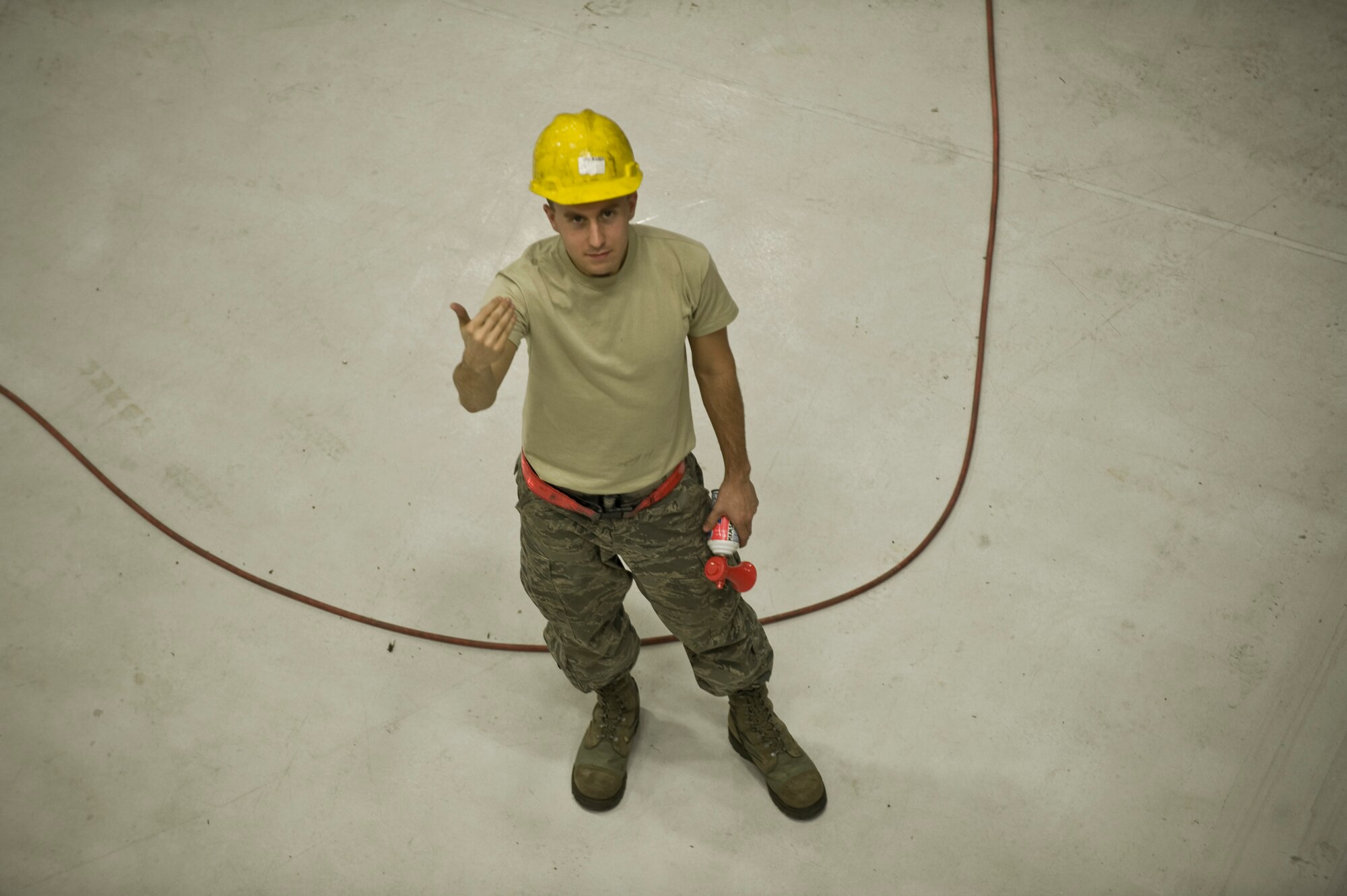 Airman 1st Class Joshua Harper, 22nd Maintenance Squadron aircraft structural maintenance apprentice, guides an Airman operating a JLG lift, Sept. 30, 2013, at McConnell Air Force Base, Kan. Harper stands ready to sound off an air horn to let the JLG operator know to stop the lift. (US Air Force photo/Airman 1st Class John Linzmeier)