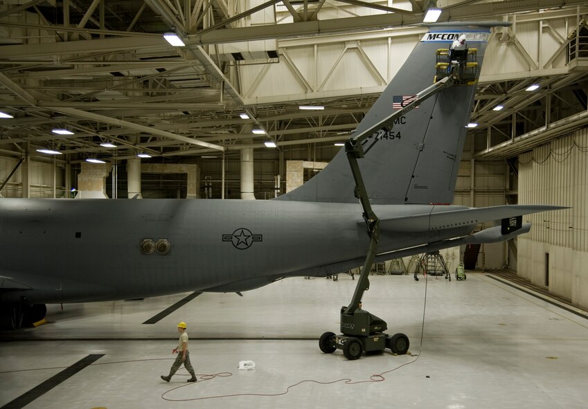 Airmen from the 22nd Maintenance group use a JLG Lift to replace the McConnell banner on the vertical stabilizer of a KC-135 Stratotanker, Sept. 30, 2013, at McConnell Air Force Base, Kan. Airmen are required to wear safety harnesses when working from high positions.(US Air Force photo/Airman 1st Class John Linzmeier)