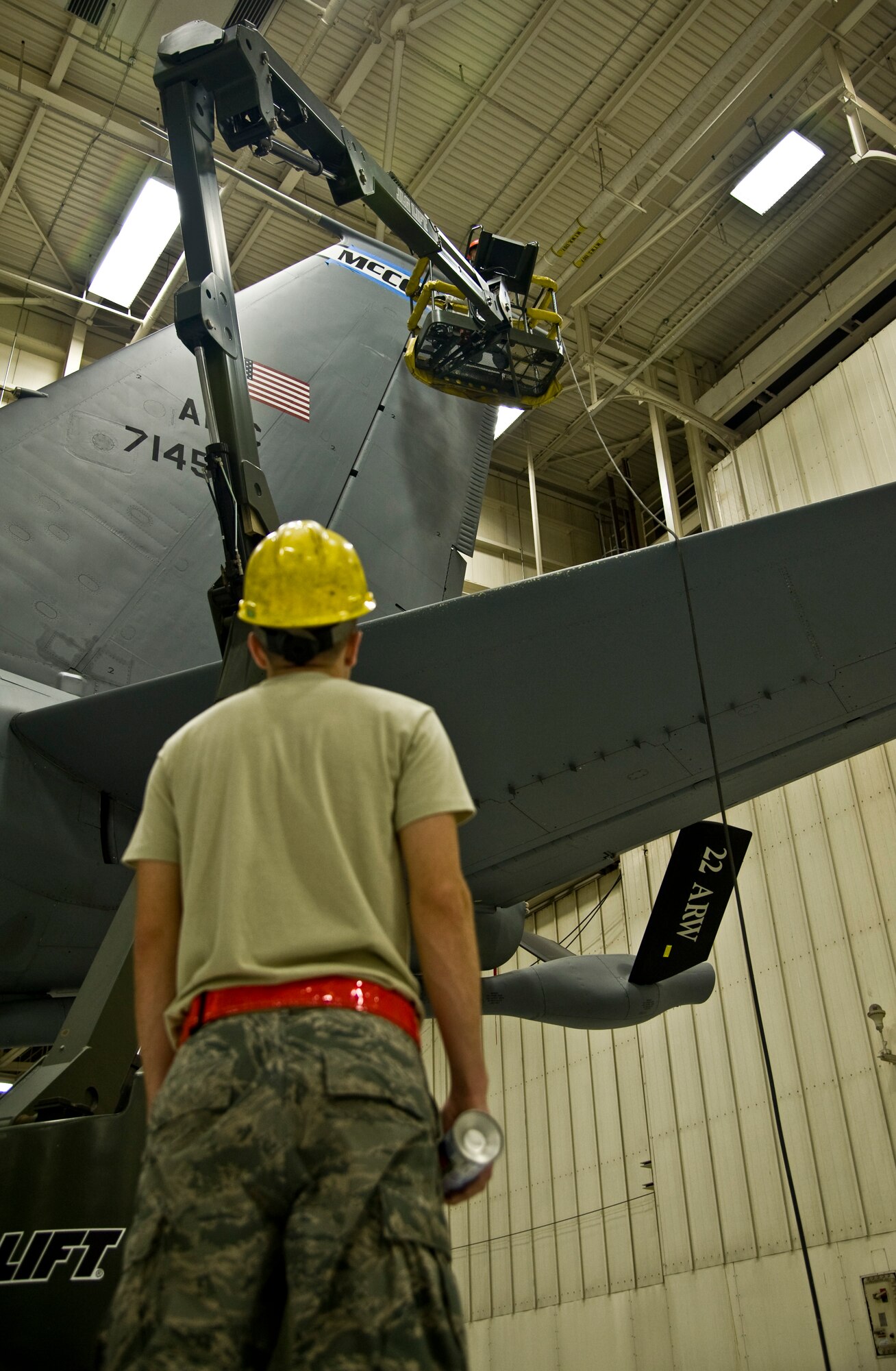 Airman 1st Class Joshua Harper, 22nd Maintenance Squadron aircraft structural maintenance apprentice, spots his wingman who is operating a JLG lift, Sept. 30, 2013, at McConnell Air Force Base, Kan. Spotters are responsible for guiding the JLG operator in order to avoid a collision with other objects. (US Air Force photo/Airman 1st Class John Linzmeier)