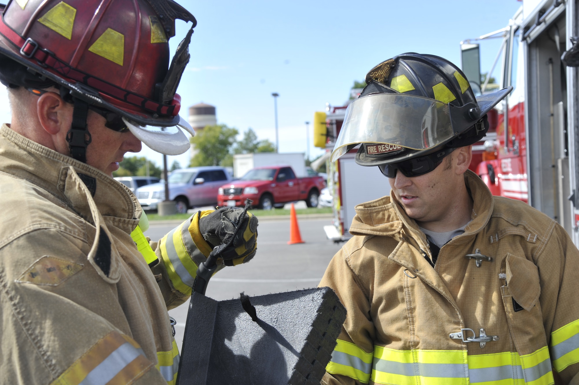 U.S. Air Force Mark Kinsey, 509th Civil Engineer Squadron fire truck crew chief, left, and Staff Sgt. Daniel Baumgarter, 509th CES fire truck crew chief, inspect cribbing at Whiteman Air Force Base, Mo., Oct. 5, 2013. Cribbing is used to stabilize a car so firefighters can help the driver. This demonstration was done during the kickoff event for the Fire Prevention Week. (U.S. Air Force photo by Airman 1st Class Keenan Berry/Released)