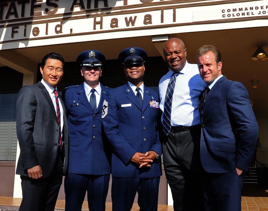 Col. Johnny Roscoe, 15th Wing commander, and Chief Master Sgt. Leslie Bramlett, 15th Wing command chief, center, pose for a group photo with “Hawaii-Five-0” cast members in front of Base Operations on prior to filming a portion of an upcoming episode at Joint Base Pearl Harbor-Hickam, Hawaii, Oct. 9, 2013. (U.S. Air Force photo/Tech. Sgt. Jerome S. Tayborn)