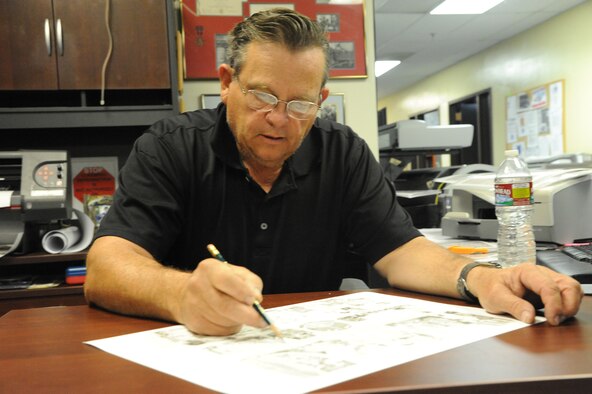 Senior Master Sgt. (ret.) Robert Stillwell, 341st Missile Wing Public Affairs graphic artist, draws a picture that represents a unit on Malmstrom Air Force Base.  Stillwell served almost 26 years in the Air Force before retiring in 1994.  (U.S. Air Force photo/Senior Airman Cortney Paxton)