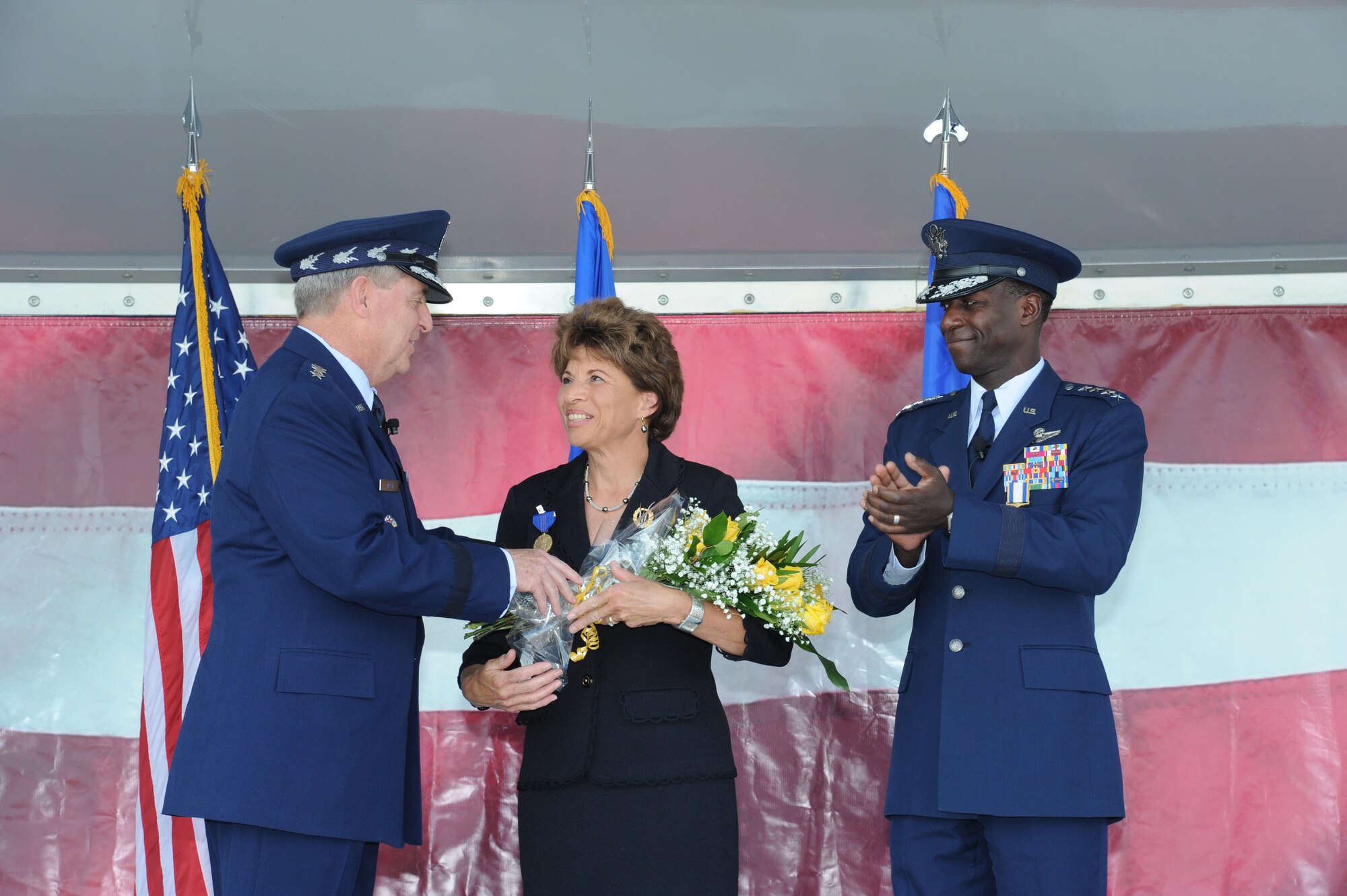 JOINT BASE SAN ANTONIO-RANDOLPH, Texas -- Teresa Rice, wife of Gen. Edward A. Rice Jr. (right), former Air Education and Training Command commander, received the Exceptional Service Award from Air Force Chief of Staff Gen. Mark A. Welsh III, for her loyalty and dedication during her husband’s 35-year U.S. Air Force career, during the AETC retirement ceremony here Oct. 10. (U.S. Air Force photo by Rich McFadden)
