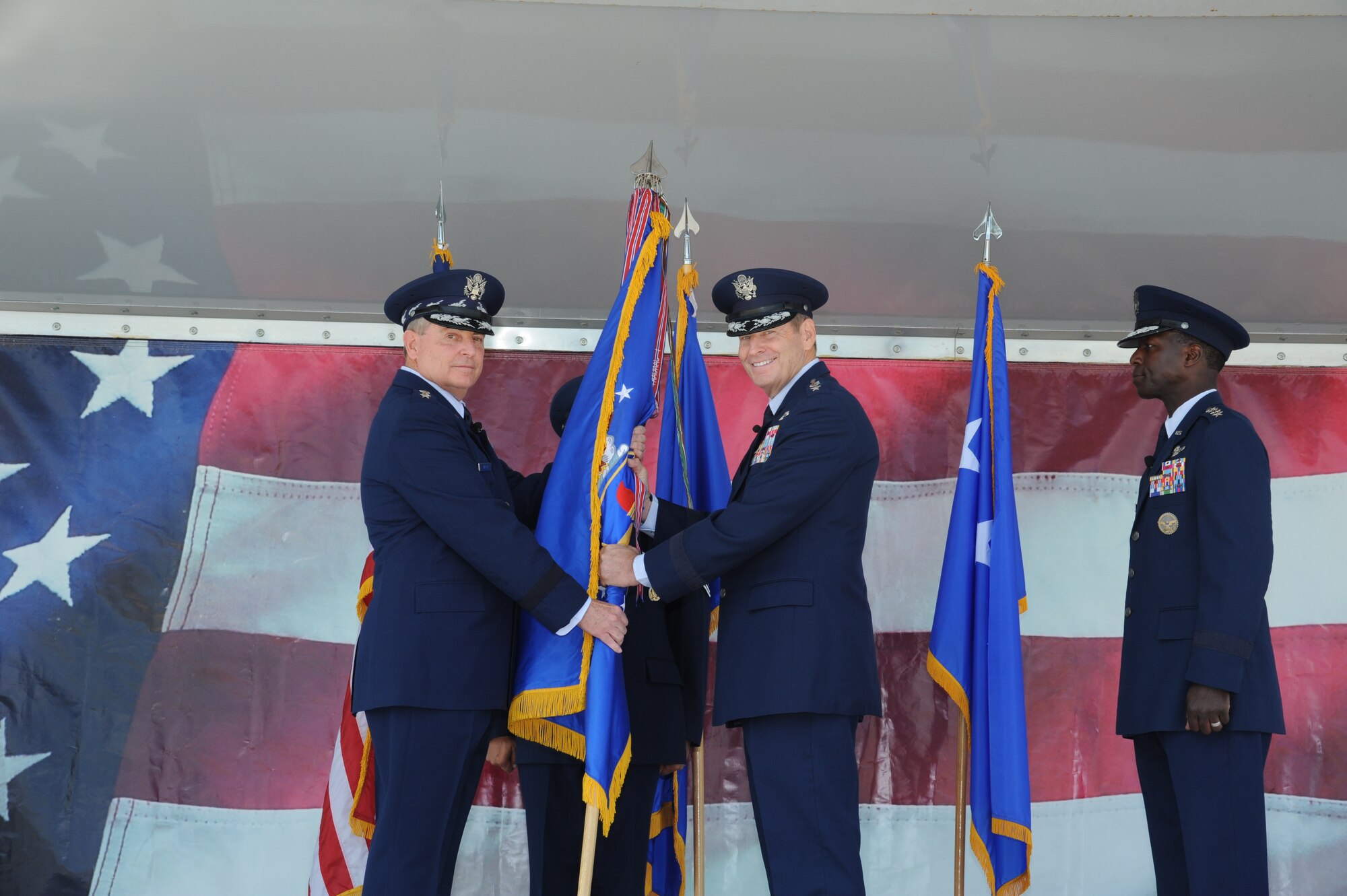 JOINT BASE SAN ANTONIO-RANDOLPH, Texas -- Air Force Chief of Staff Gen. Mark A. Welsh III (left) gives the Air Education and Training Command flag Gen. Robin Rand, officially making him the new AETC commander here Oct. 10. (U.S. Air Force photo by Rich McFadden)